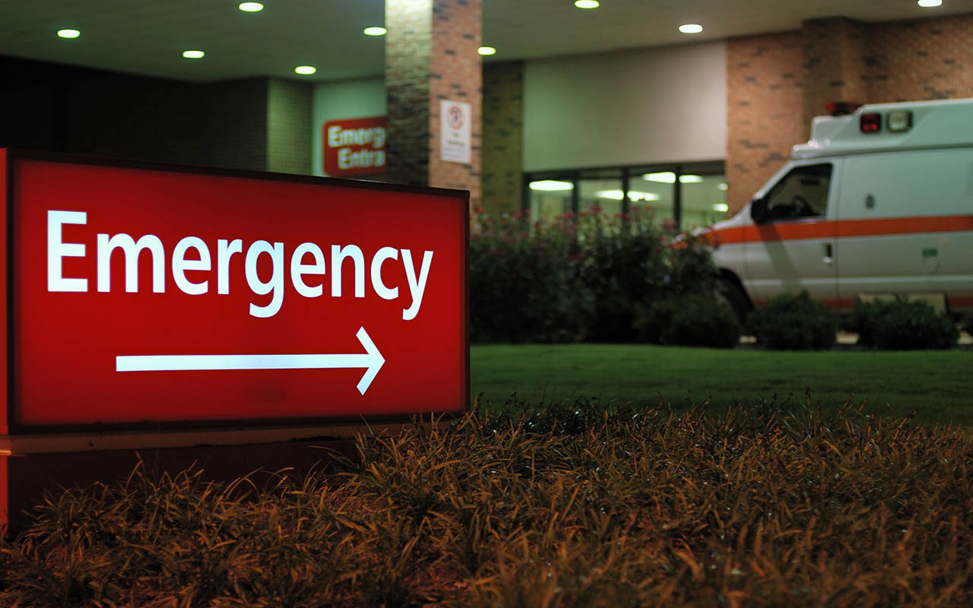 Emergency room entrance at night with ambulance