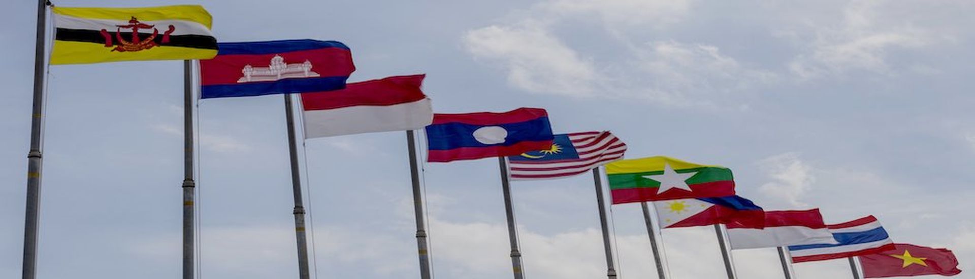 National flags of countries who are member of AEC (ASEAN economic community) on blue sky background