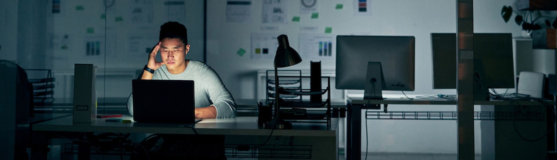 Shot of a young businessman looking stressed during a late night in a modern office