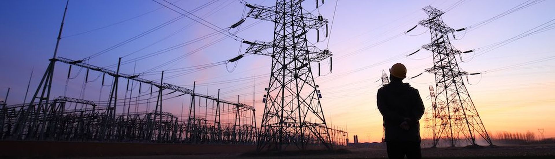 In the evening, electricity workers and pylon silhouette, Power workers at work