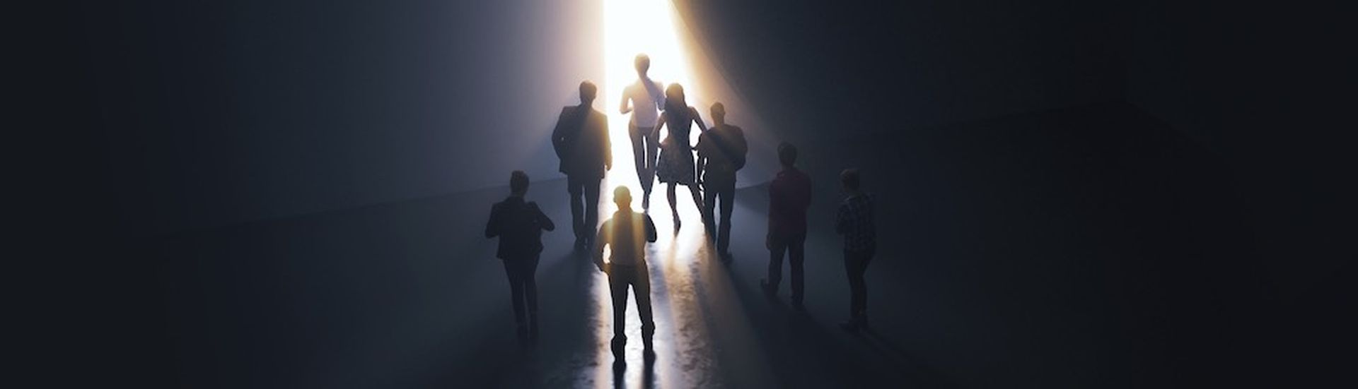 group of people at the door leading to the light