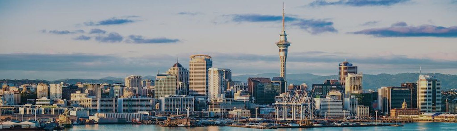 An early morning view of the CBD of Auckland, across the water of Waitemata Harbor.