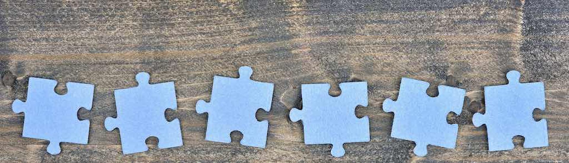 Puzzle pieces on wooden table