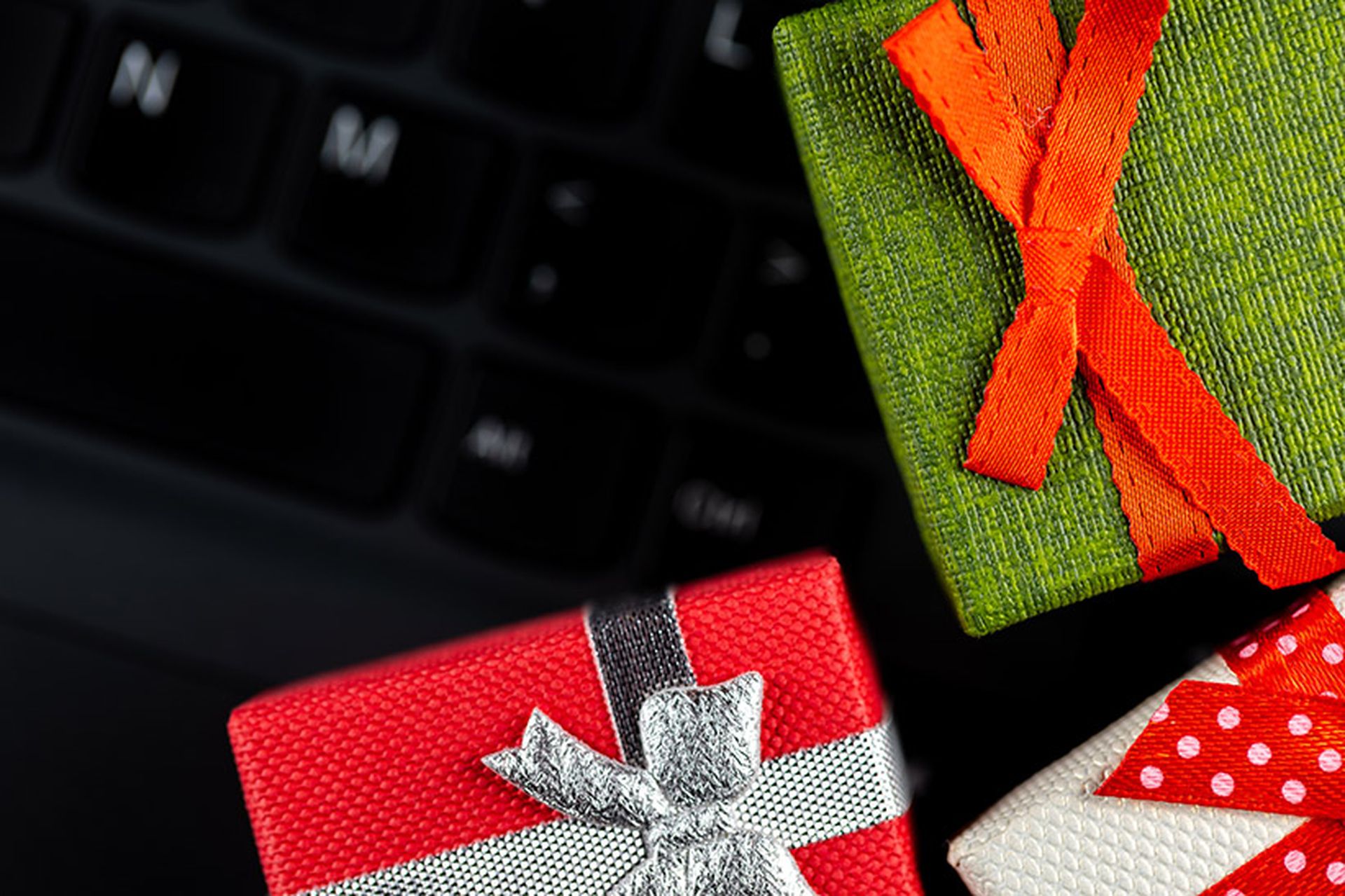 Small gift boxes arranged on the laptop keyboard. Cybersecurity of online shopping.