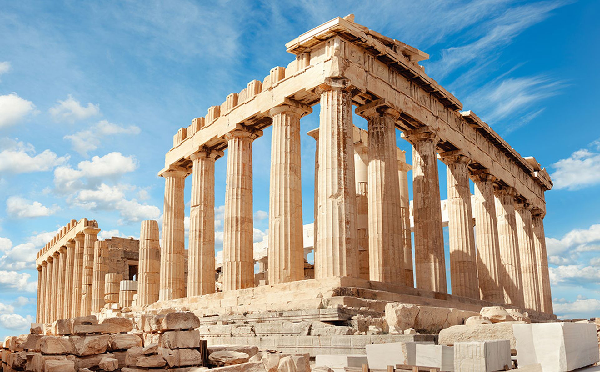 The Parthenon in Athens, Greece, on a sunny day against a blue sky.