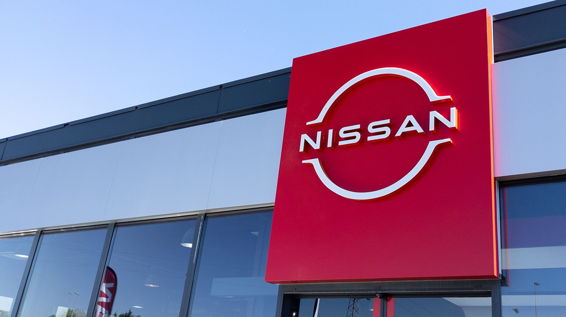 Nissan logo brand and text sign for dealership store of Japanese car shop