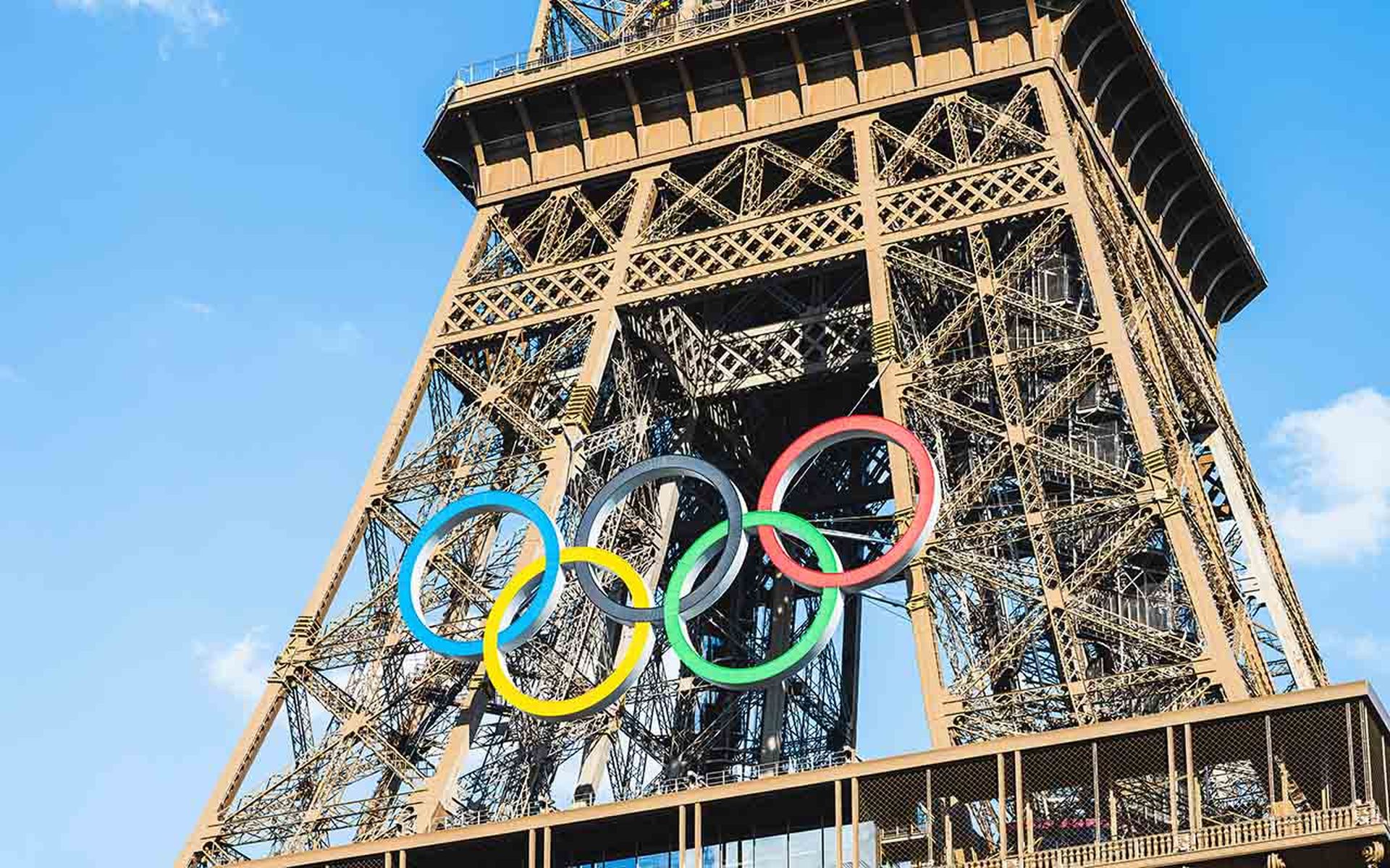 The multi-colored Olympic rings are seen on the Eiffel Tower in Paris