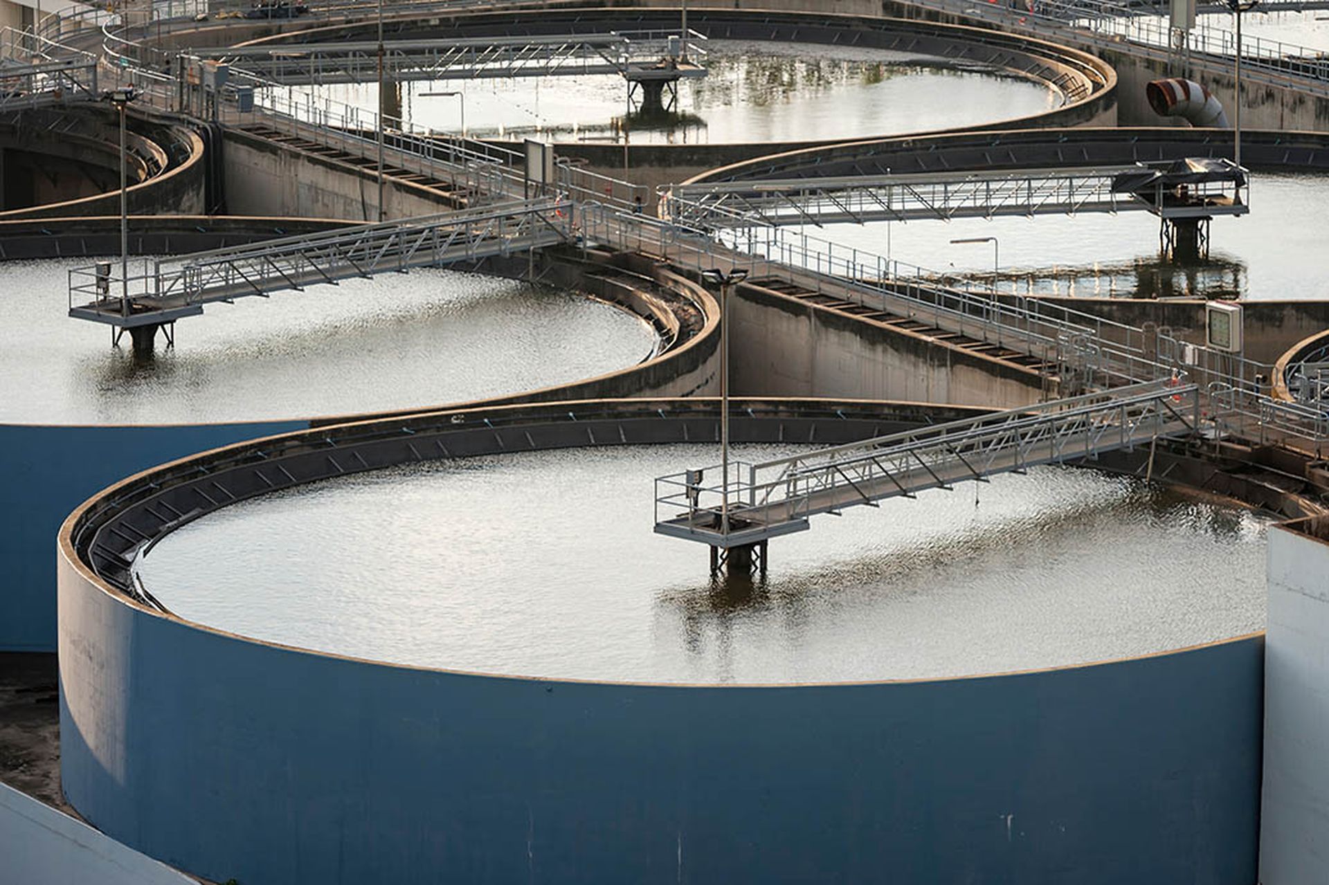 Modern urban wastewater treatment plant.Water purification is the process of removing undesirable chemicals, suspended solids and gases from contaminated water. Water cleaning facility outdoors.