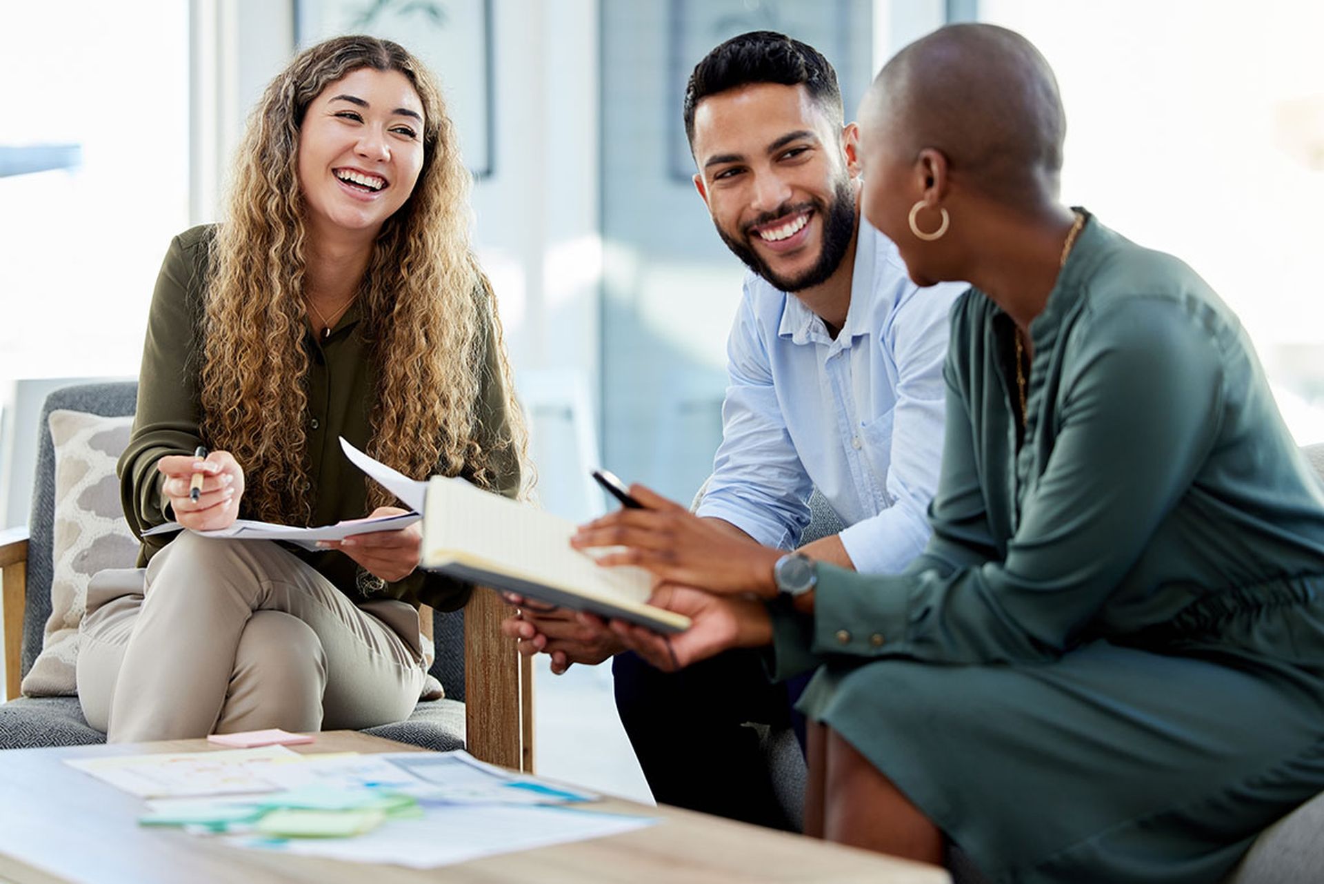 Happy business people smile during a planning meeting in a startup marketing agency office.