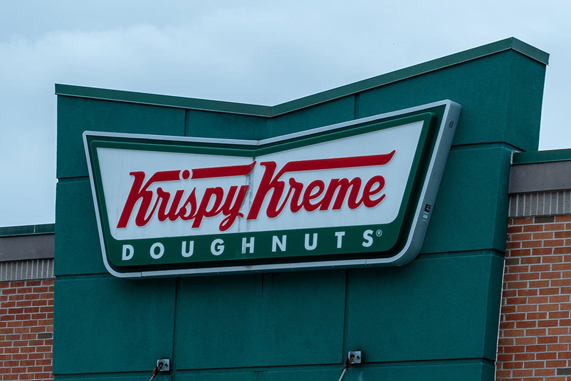 Closeup of Krispy Kreme restaurant sign on the building.