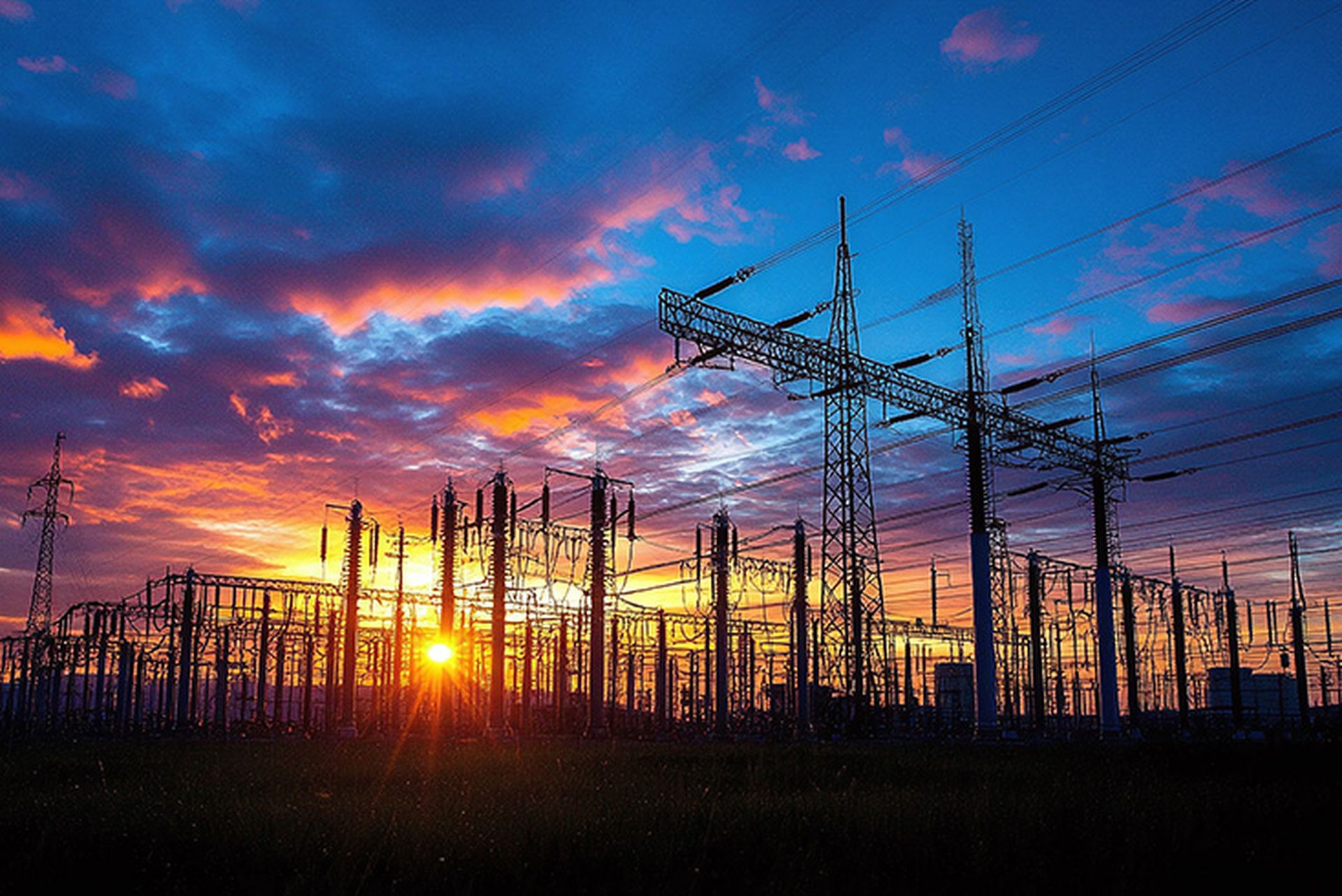 dusk view of electricity grid infrastructure emphasizing the critical protection needed for power transmission and distribution systems to ensure a reliable energy network