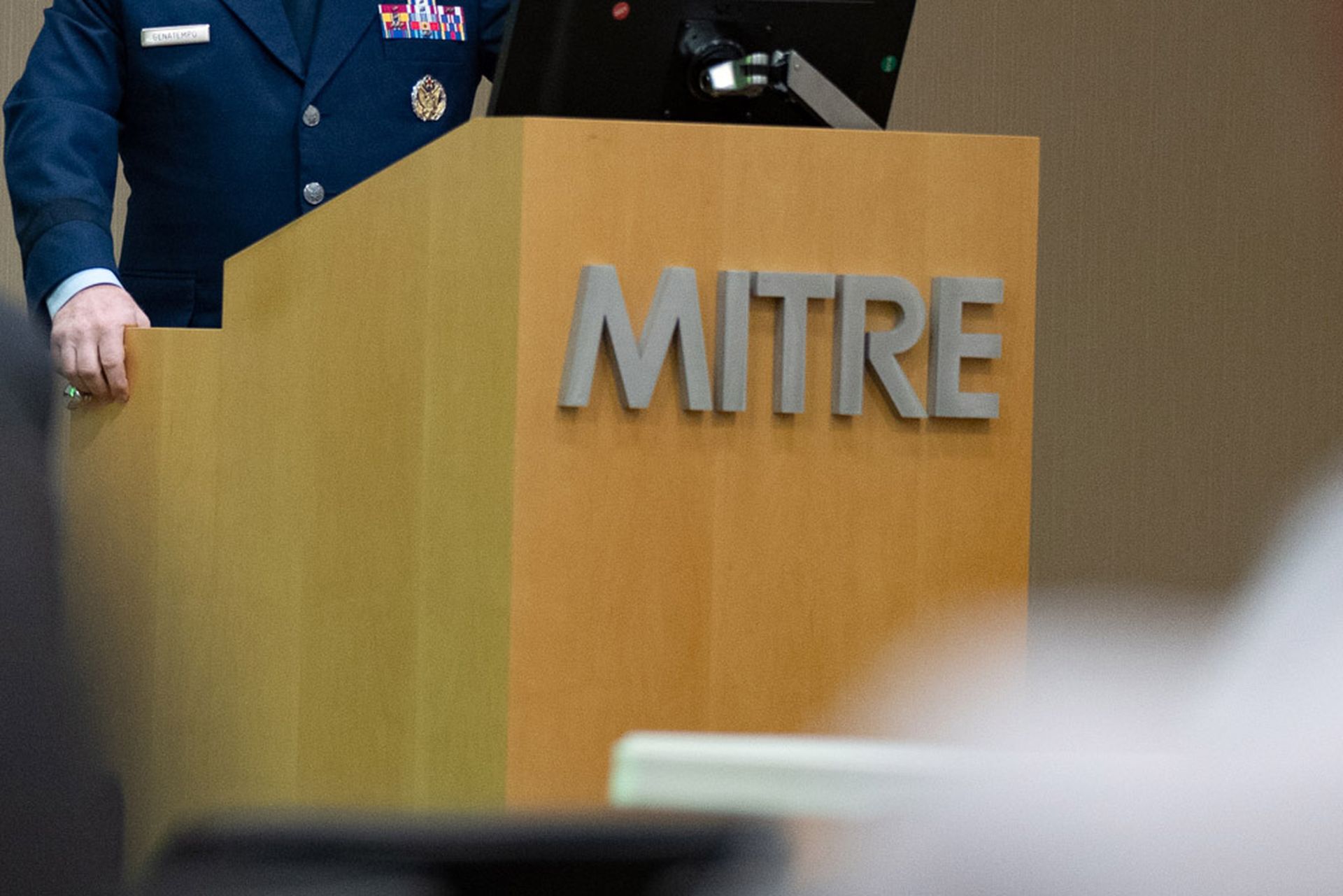 A speaker presents at the MITRE Corporation in Bedford, Mass. (Air Force)