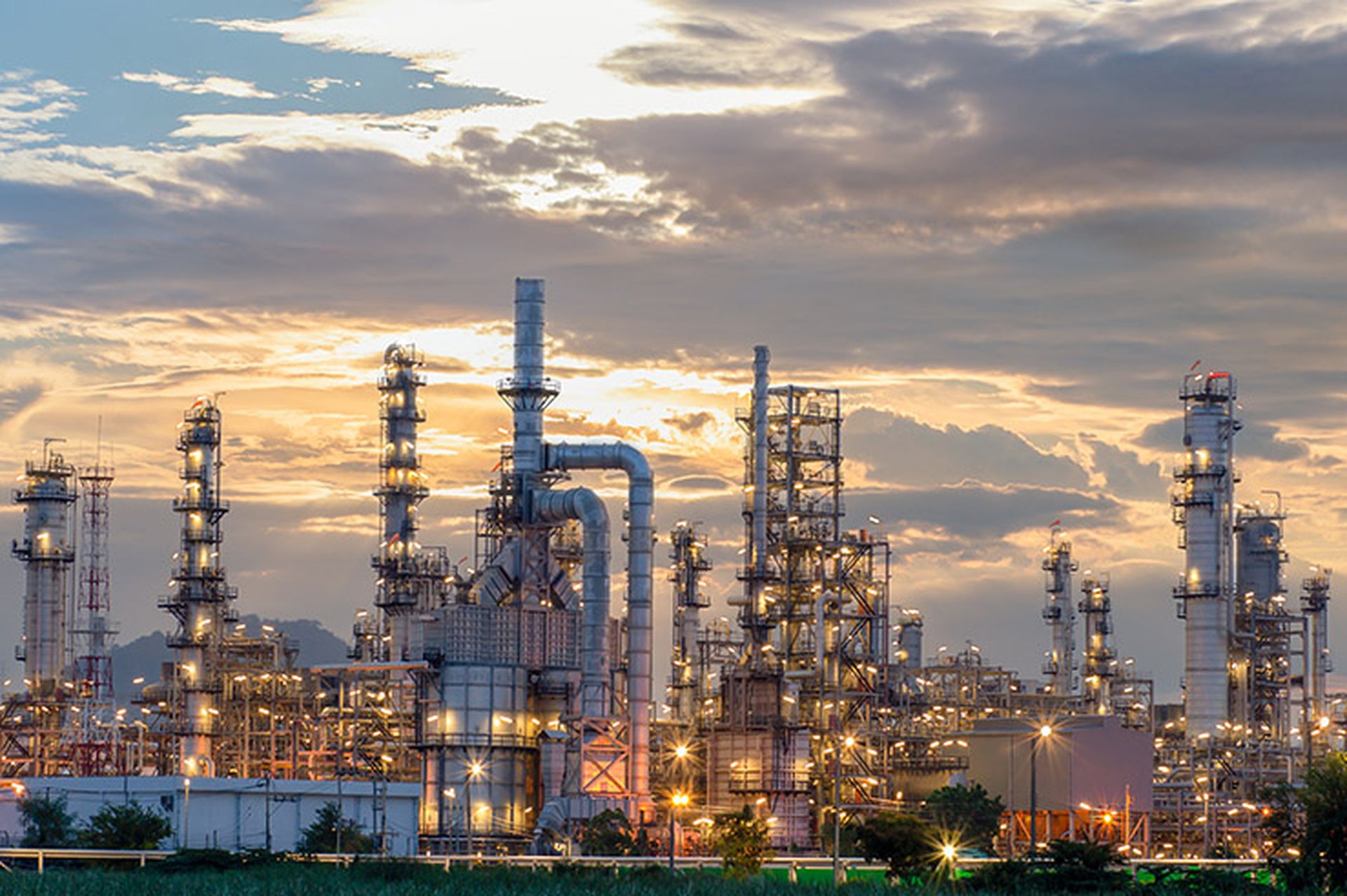 Oil refinery plant from industry zone, Aerial view oil and gas industrial, Refinery factory oil storage tank and pipeline steel at night.
