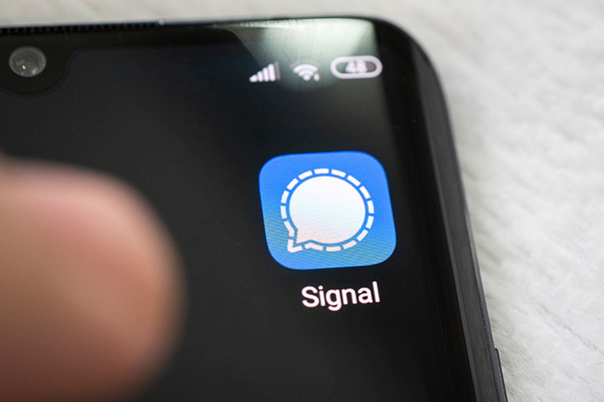 The Signal app icon on a smartphone.