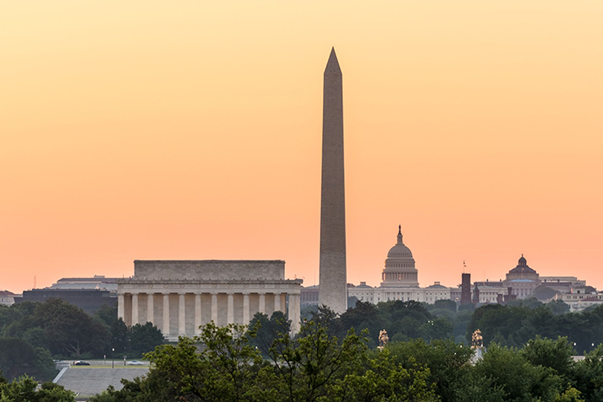 Dawn and sunrise over nations capital with all monuments aligned against orange sky