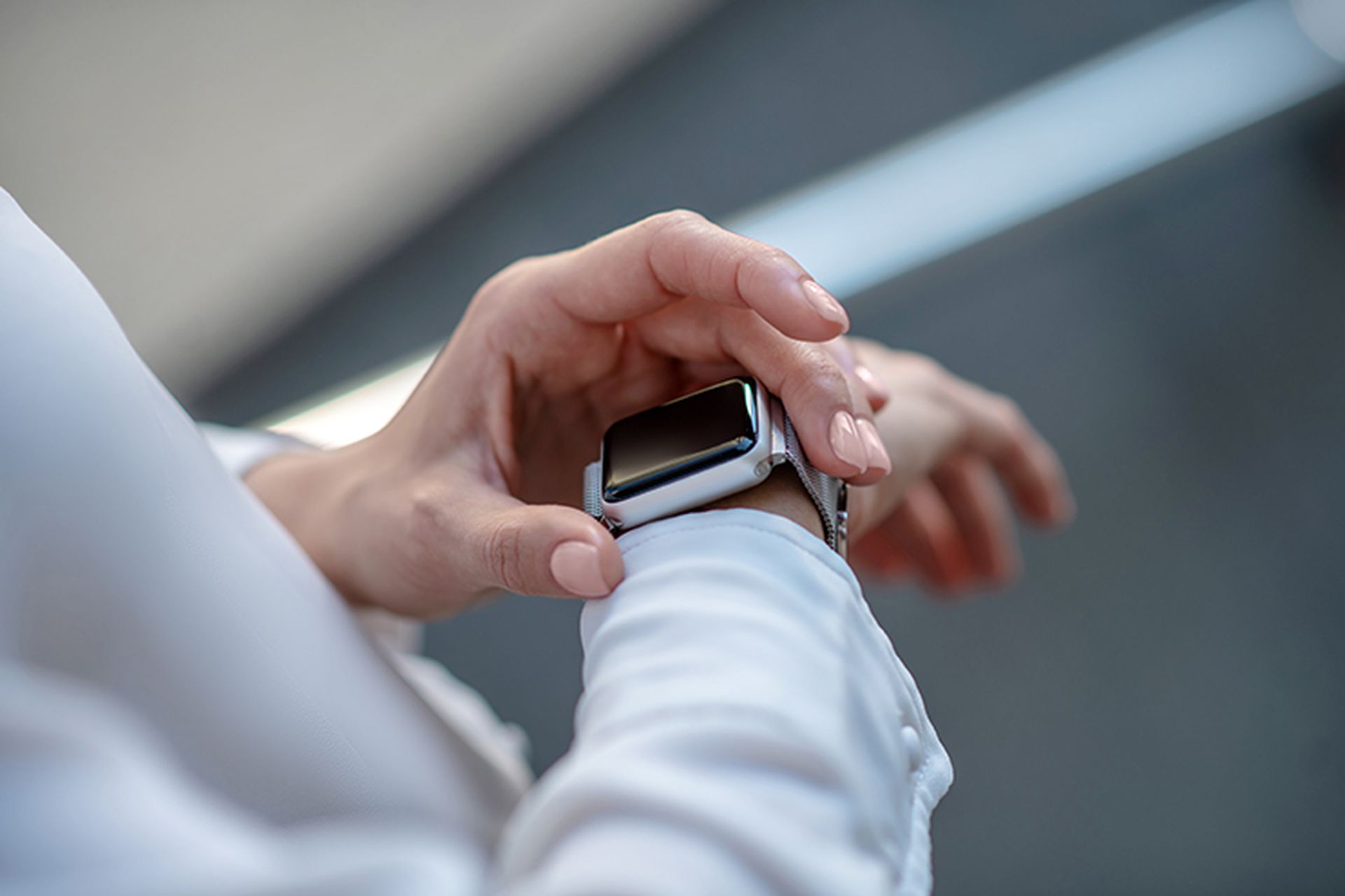 Gadget. Close up picture of a womans hands touching a smartwatch