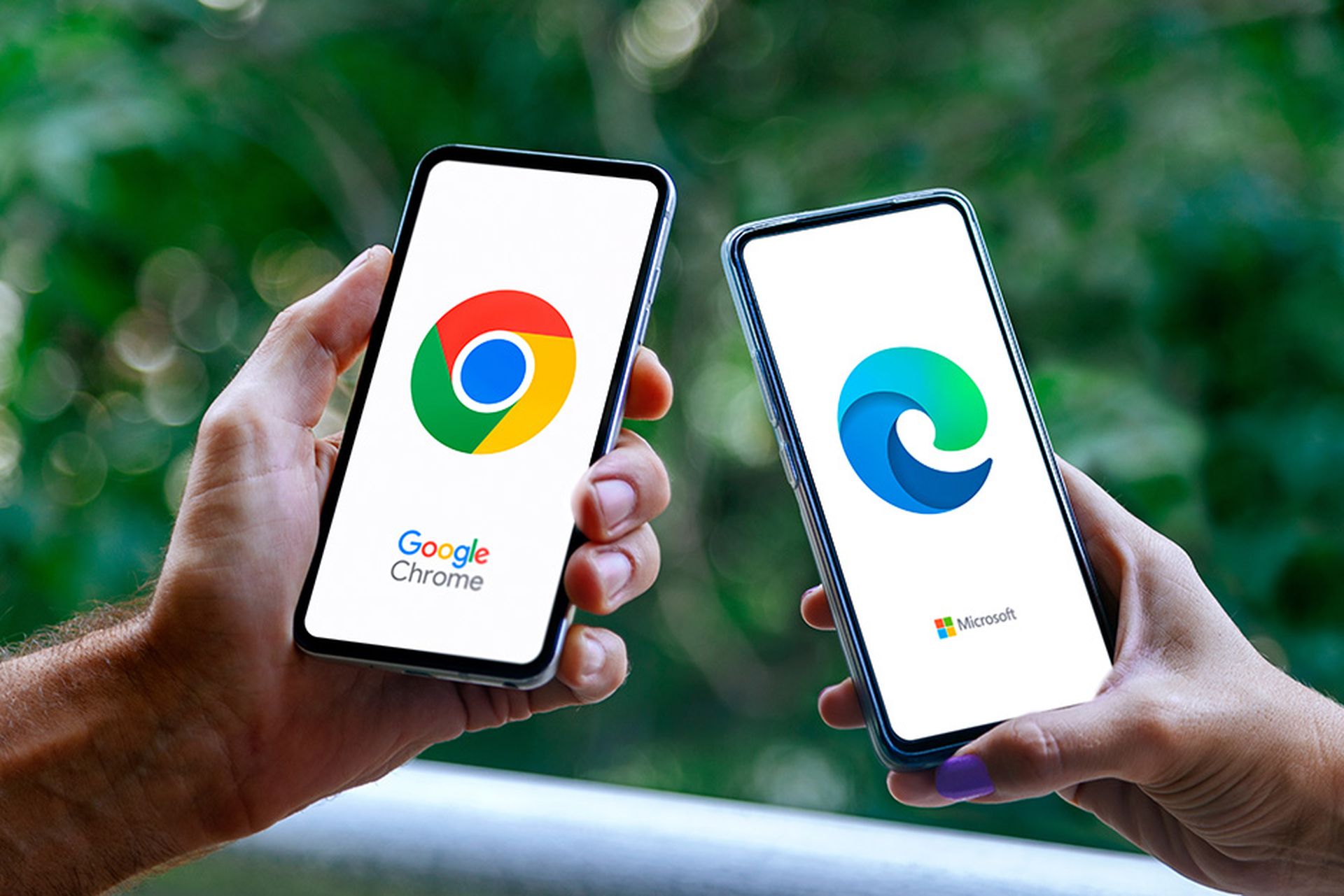 Hands of two people with mobile phones showing the chrome browser on one and microsoft edge on the other.