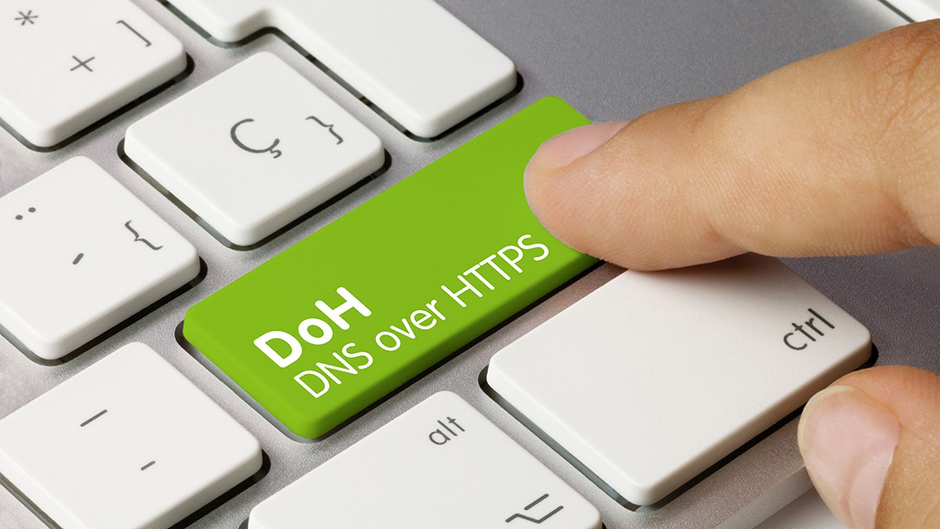 DoH DNS over HTTPS Written on Green Key of Metallic Keyboard. Finger pressing key.