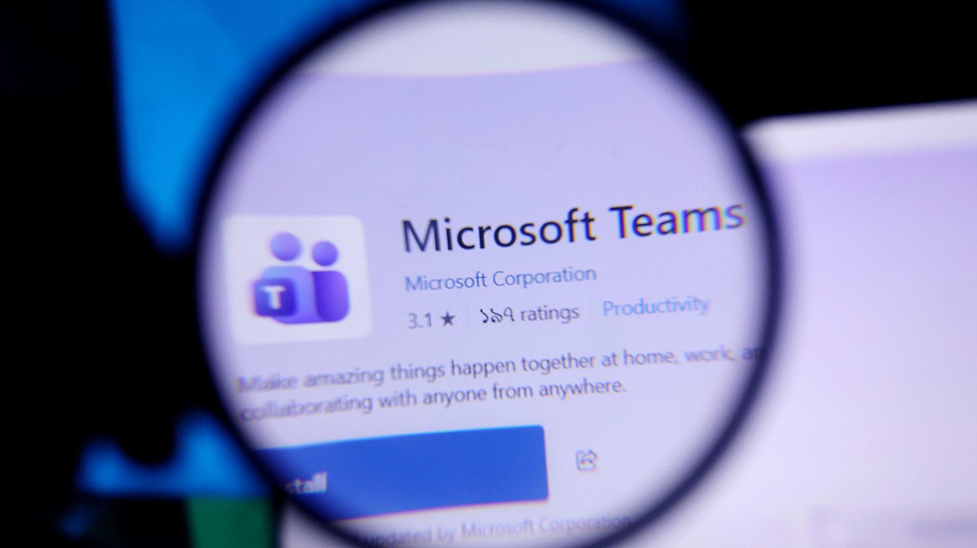 Microsoft teams app logo on a computer screen through magnifying glass