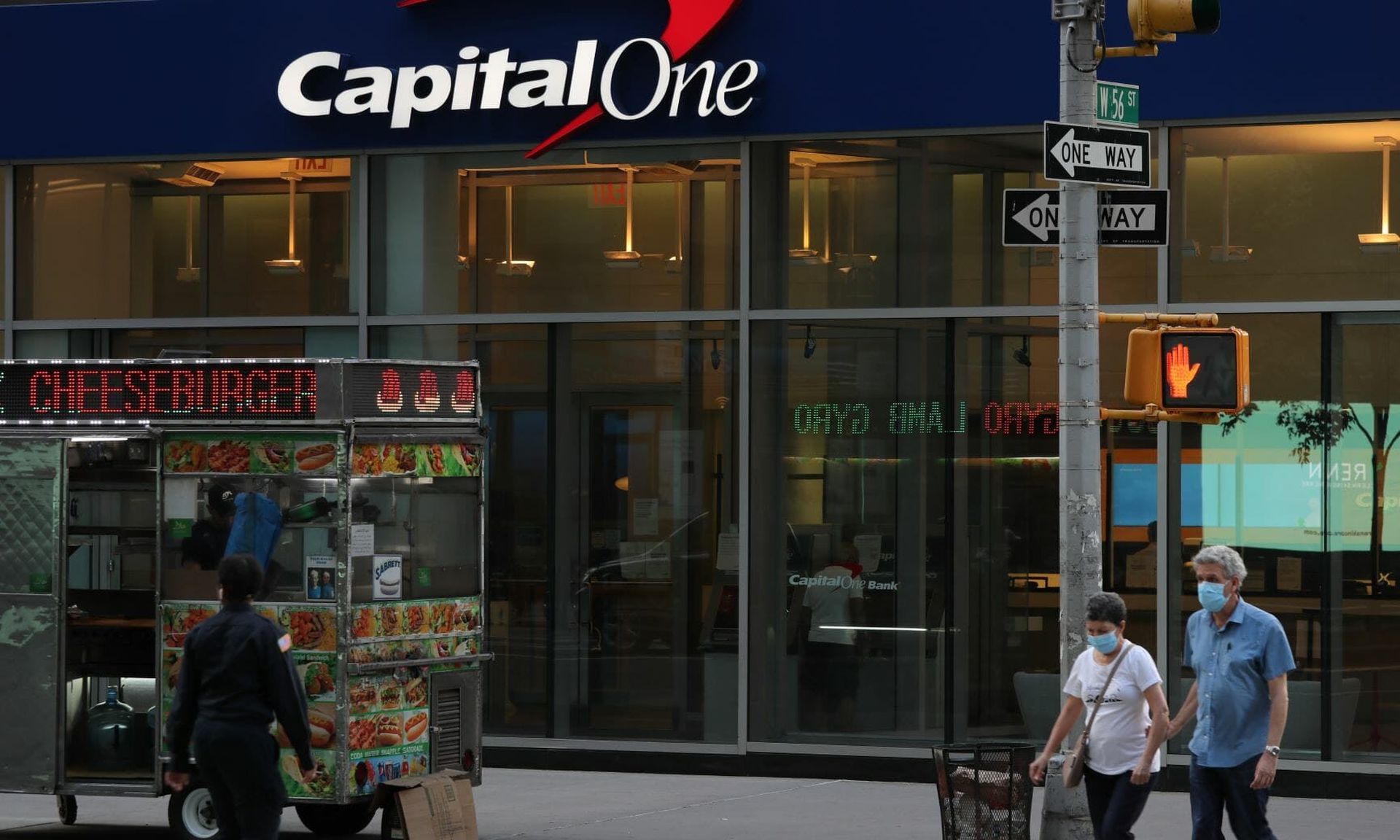 People walk near a Capital One Bank in New York City. The financial firm received a hefty fine from the OCC and a cease and desist order from the Federal Reserve after a massive breach exposed data on 100 million customers. (Photo: Rob Kim/Getty Images)