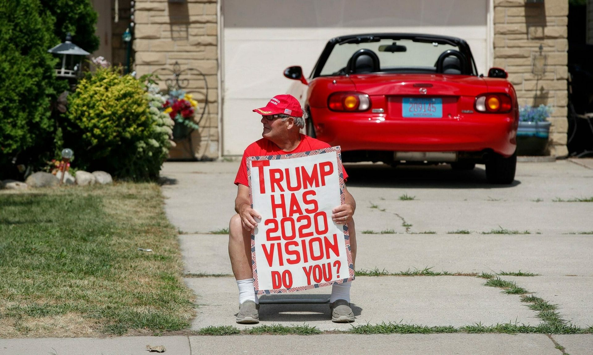 A Donald Trump supporter holds a poster before a rally with the U.S. President in Oshkosh, Wisconsin, on August 17, 2020.  (KAMIL KRZACZYNSKI/AFP via Getty Images)