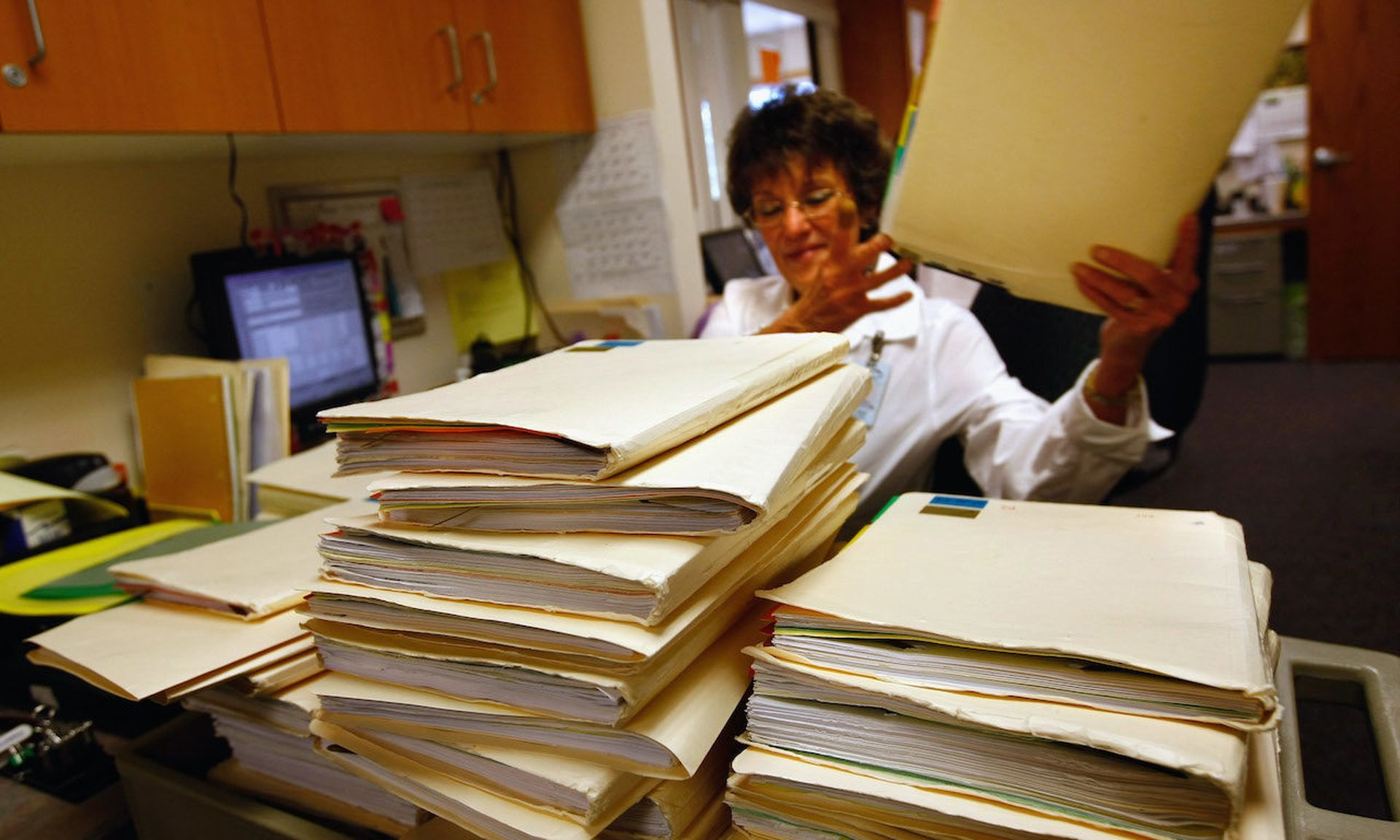 An office assistant searches for a patient&#8217;s misplaced medical file at a family clinic amid a transition to an electronic health records system. (Photo by John Moore/Getty Images)