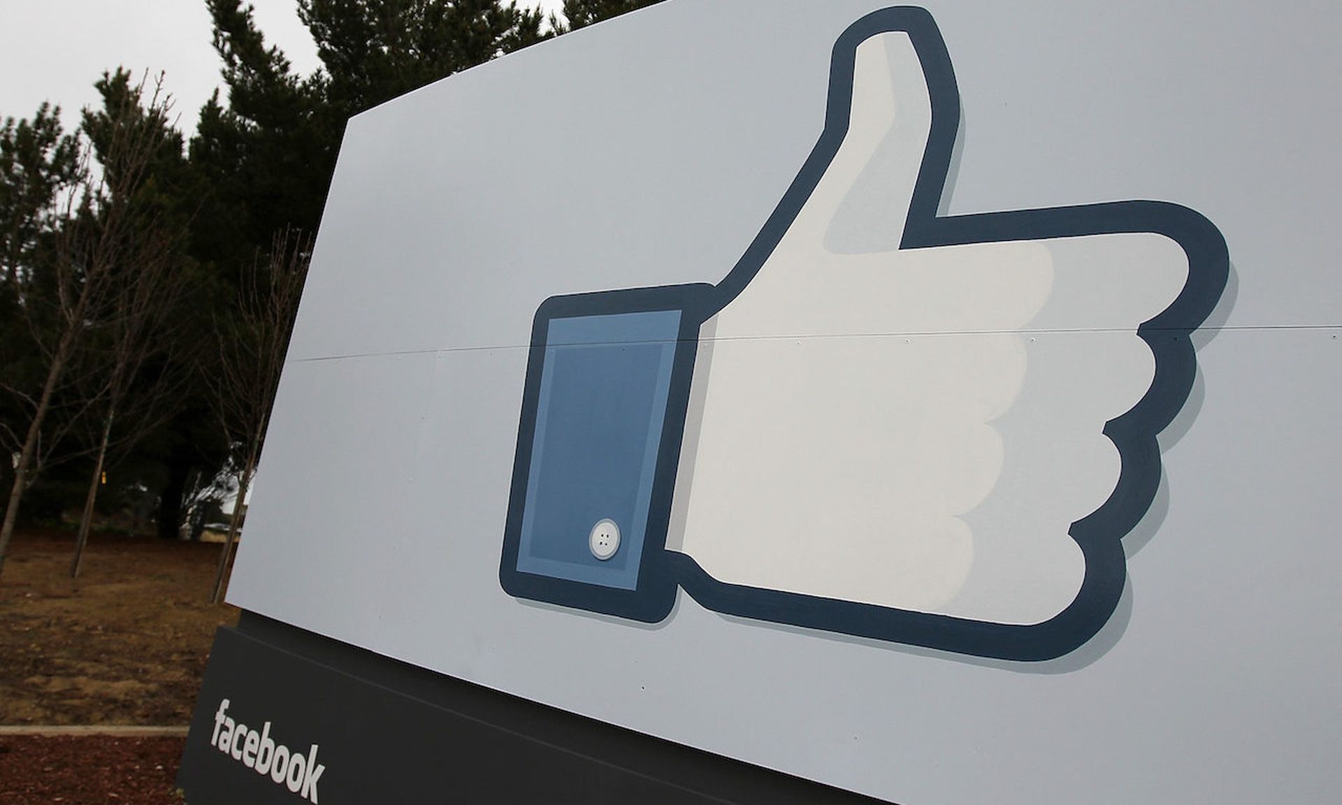 A sign with the &#8220;like&#8221; symbol stands in front of the Facebook headquarters in Menlo Park, California. Facebook is among the companies that would like to incorporate end-to-end encryption to benefit users. (Photo by Justin Sullivan/Getty Images)