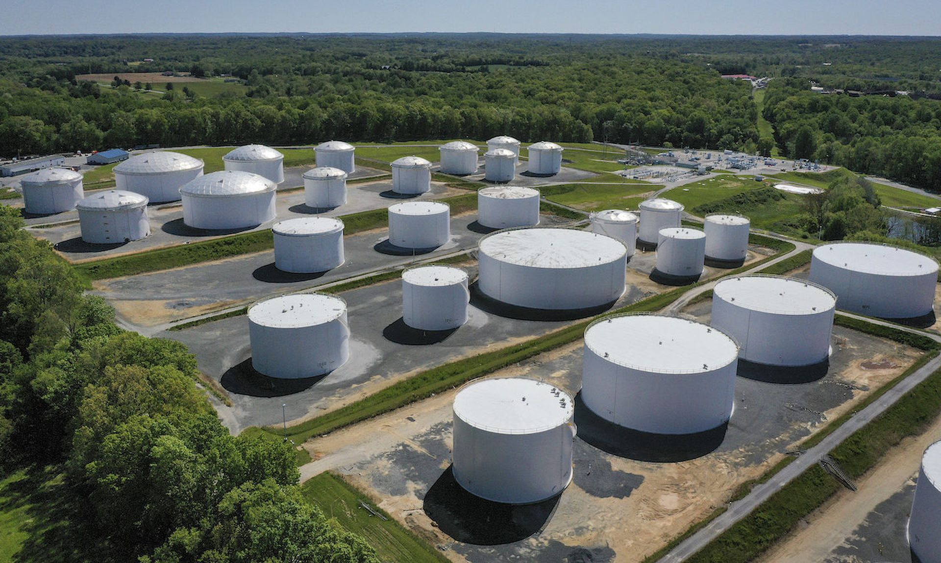 In an aerial view, fuel holding tanks are seen at Colonial Pipeline&#8217;s Dorsey Junction Station on May 13, 2021 in Washington, DC. The Colonial Pipeline has returned to operations following a cyberattack that disrupted gas supply for the eastern U.S. for days. (Photo by Drew Angerer/Getty Images)