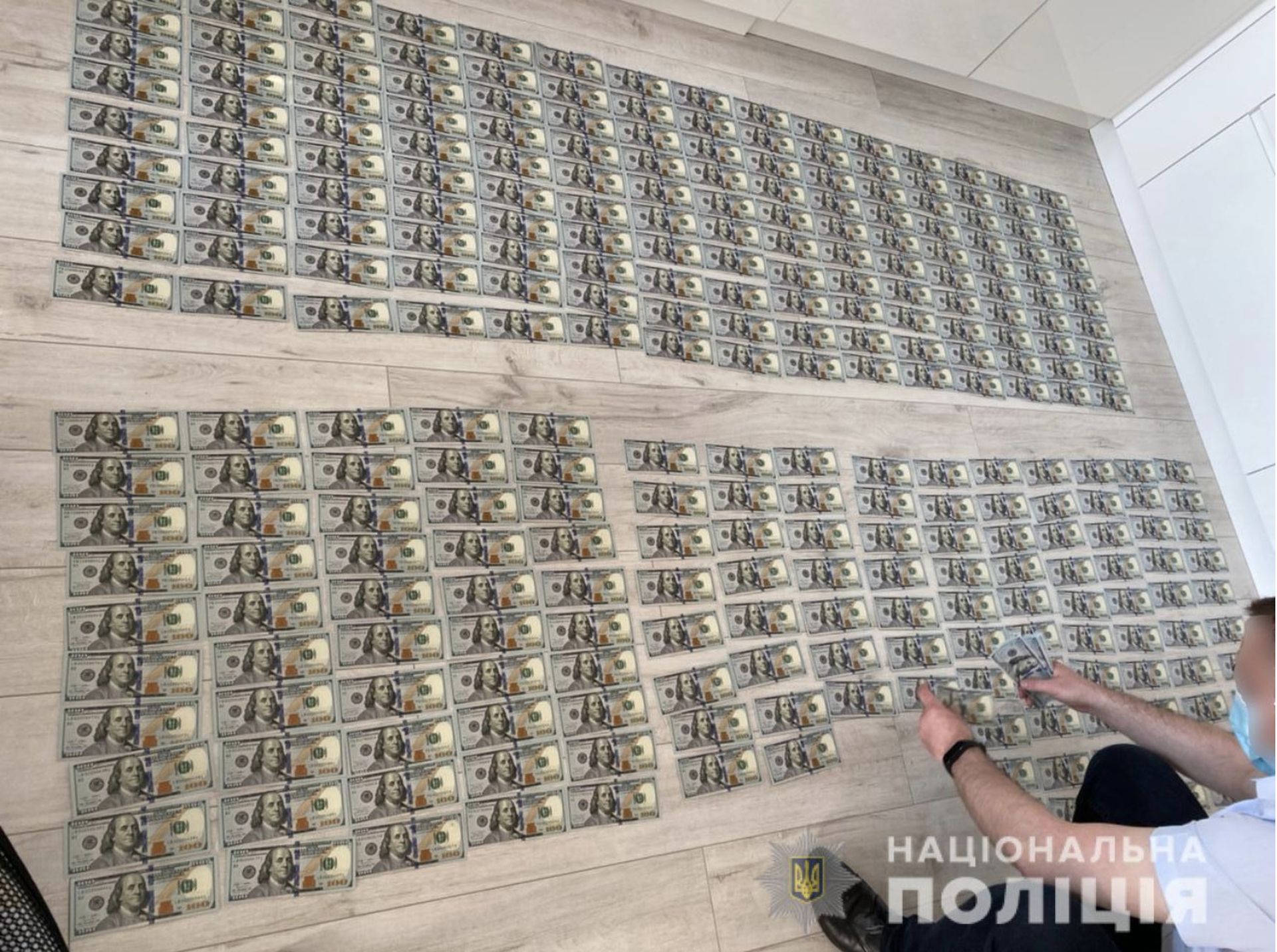 Ukrainian authorities display seized money in a June 15 raid that resulted in the arrest of six individuals alleged to be part of the Cl0p ransomware gang. (Credit: Ukrainian Cyber Police)