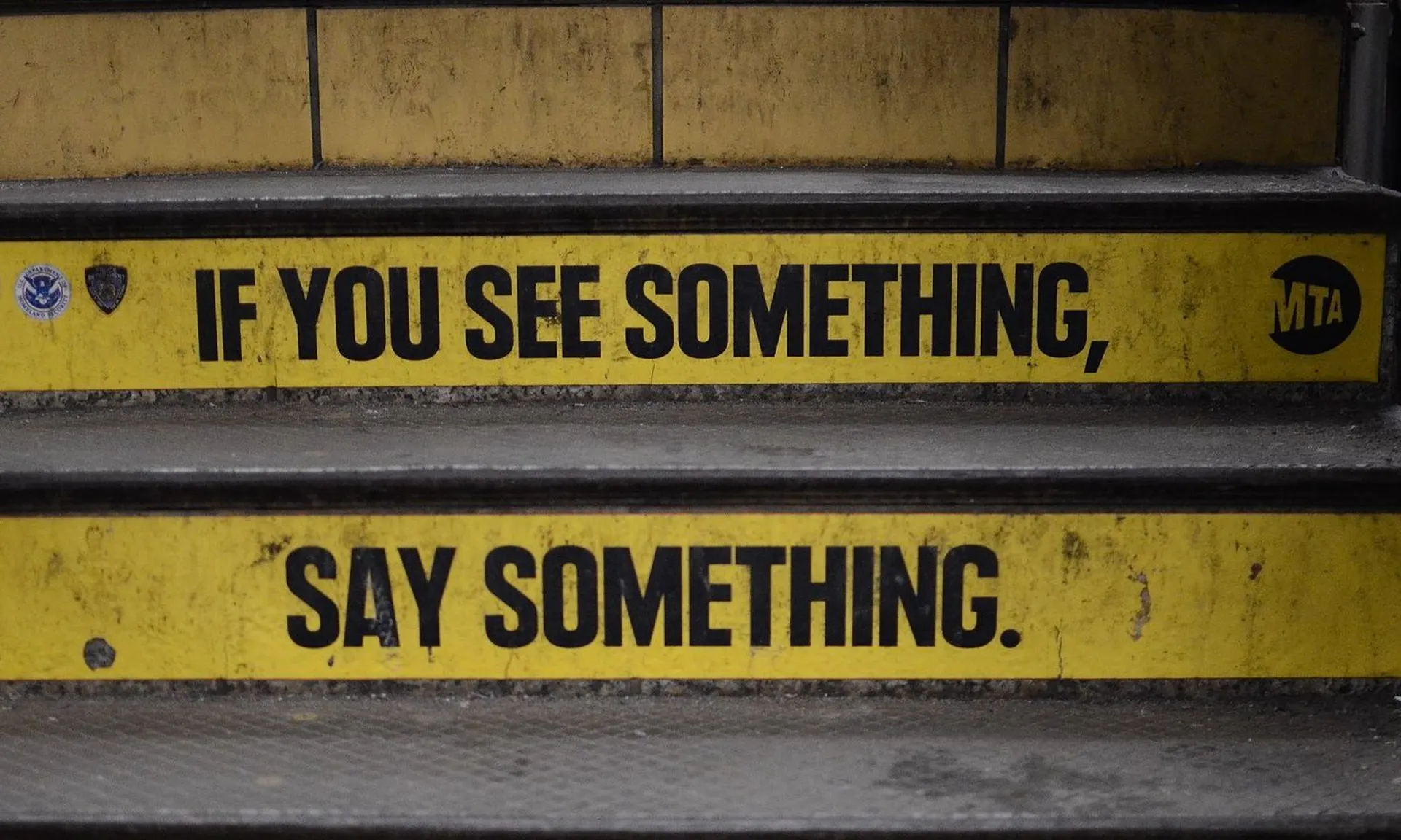 If you see something, say something, shown on the 42nd street subway. Experts are voicing the importance of creating a corporate culture that rewards cyber vigilance and removes the stigma of human error, which can sometimes silence those that recognize risks.(Credit: Steven Lek is licensed under https://creativecommons.org/licenses/by-sa/4.0/)