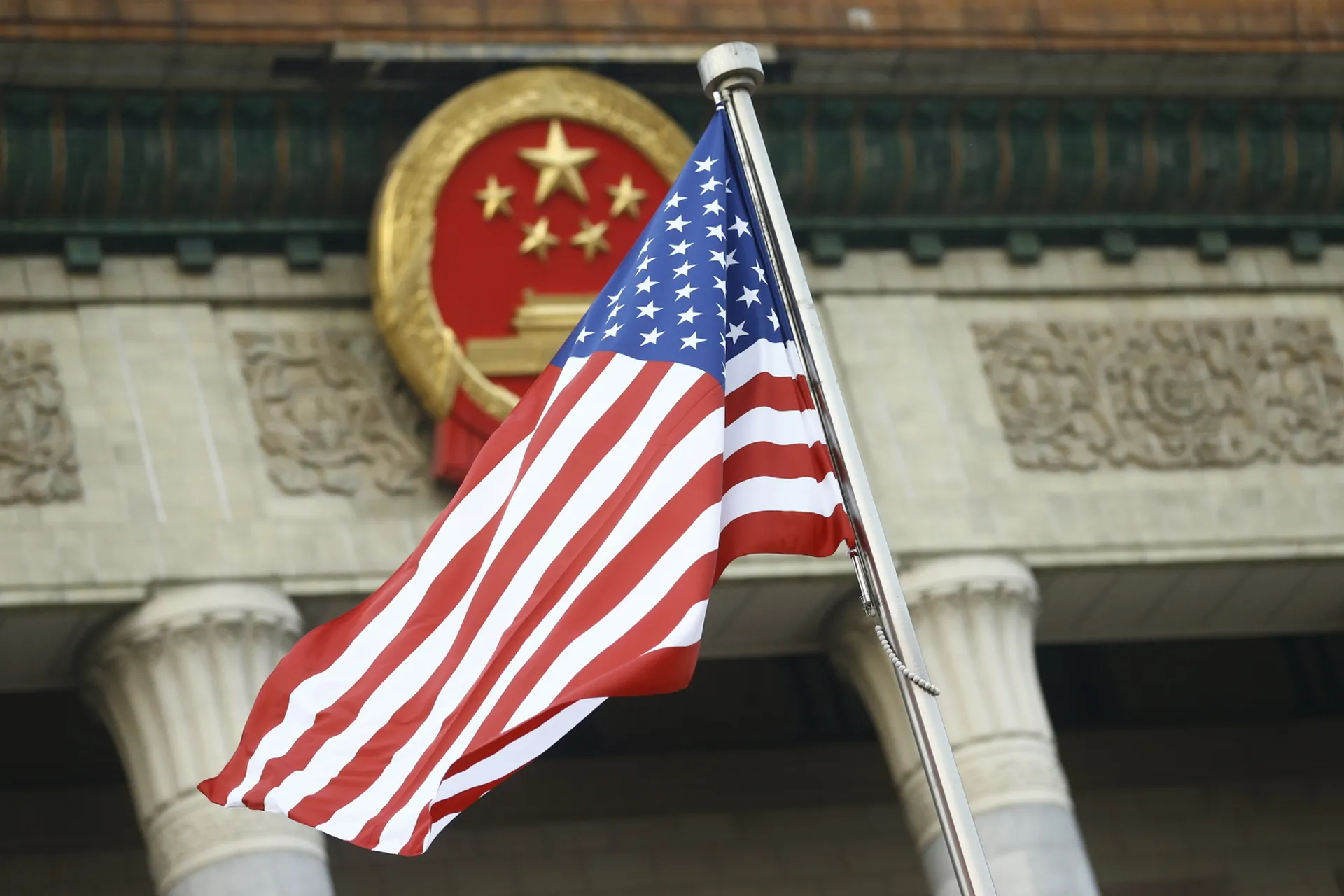 The U.S. flag flies at a welcoming ceremony between Chinese President Xi Jinping and U.S. President Donald Trump Nov. 9, 2017, in Beijing. The U.S. is sending mixed messages on how it deals with cyber threats by China and Russia, experts say. (Thomas Peter-Pool/Getty Images)