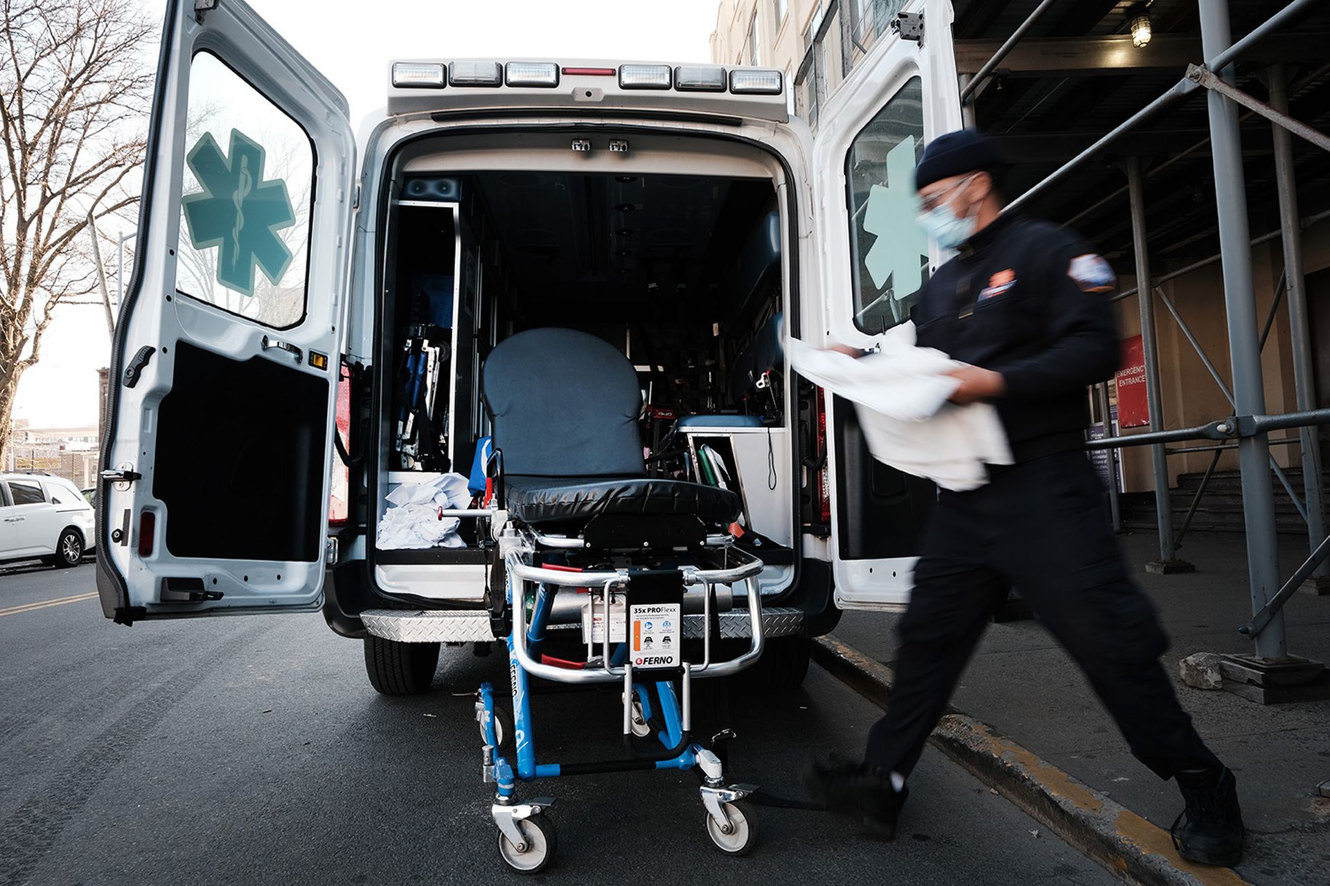 An EMT worker cleans a gurney after transporting a suspected Covid patient outside of a Brooklyn hospital on March, 29 2021, in New York City. Incidents at several hospitals nationwide have led to breaches of patient data. (Photo by Spencer Platt/Getty Images)