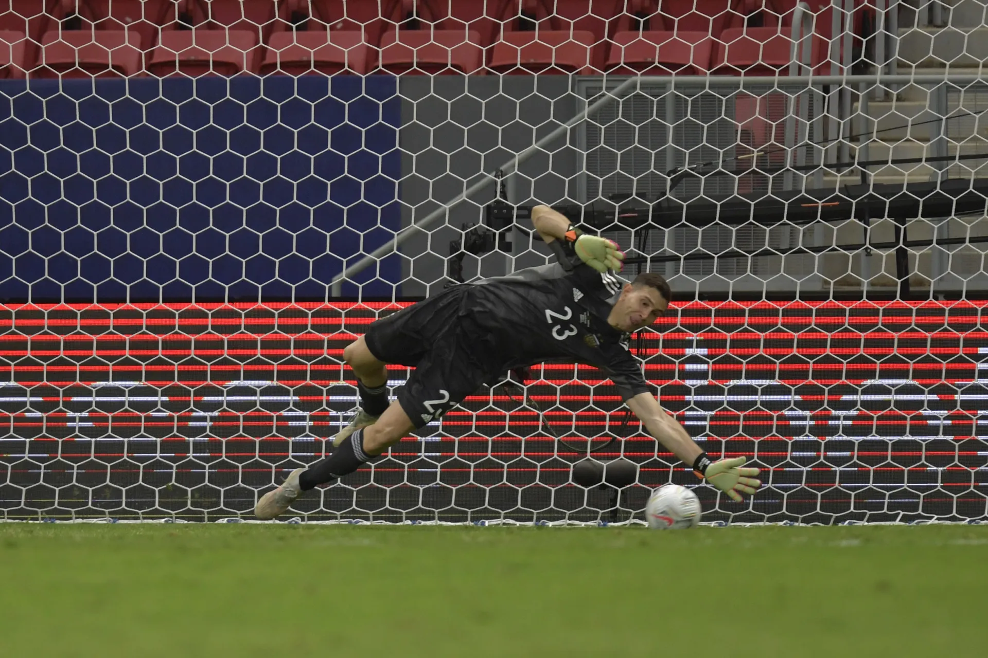 Argentinian goalie Emiliano Martinez dives to save penalty kick during the semi-final match of Copa America Brazil 2021 last July. (Photo by Pedro Vilela/Getty Images)