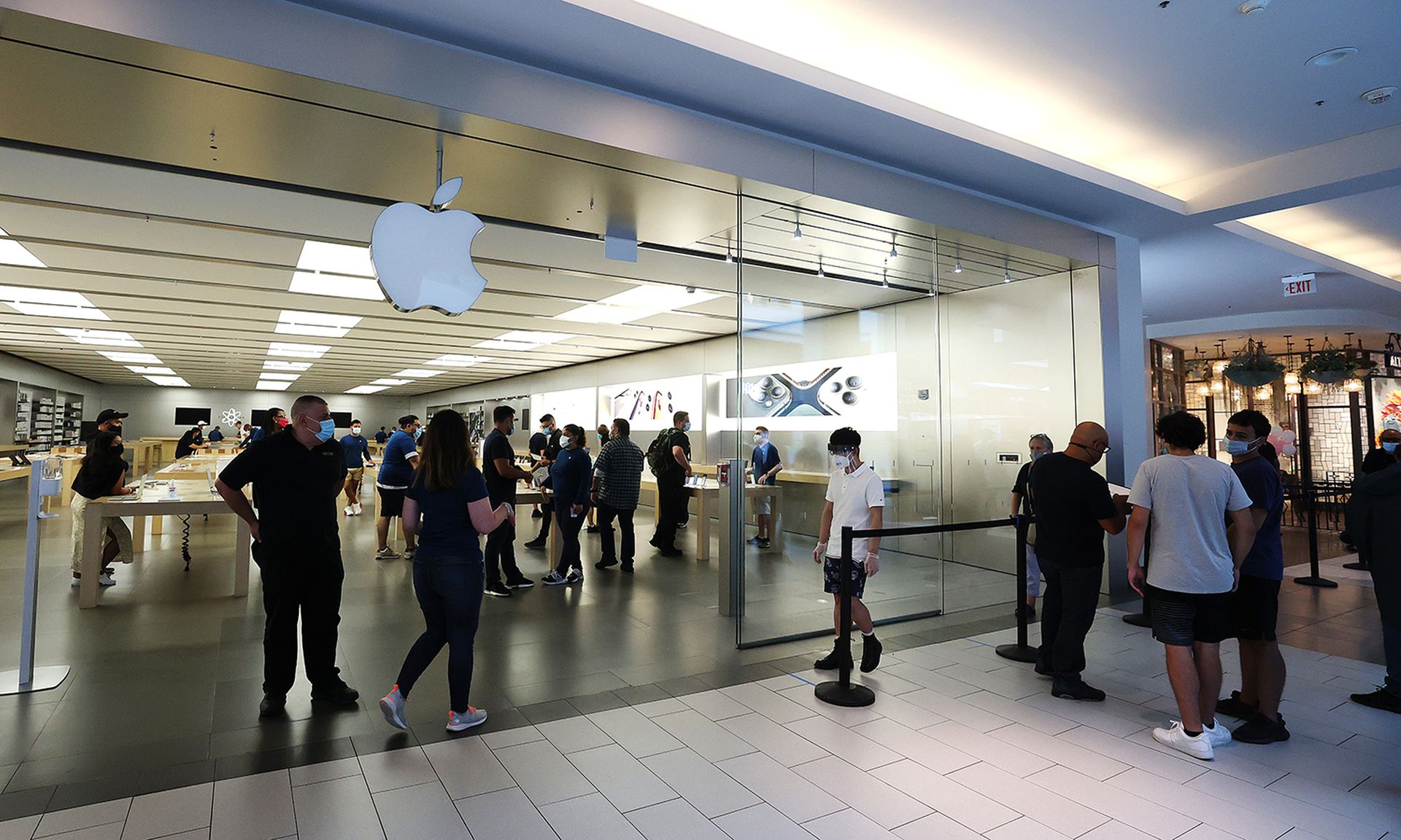 Customers shop at the Apple store at Roosevelt Field Mall on July 10, 2020, in Garden City, N.Y. Researchers at North Carolina State University found an iPhone vulnerability that allows attackers to gain access to to cryptographic keys. (Photo by Al Bello/Getty Images)