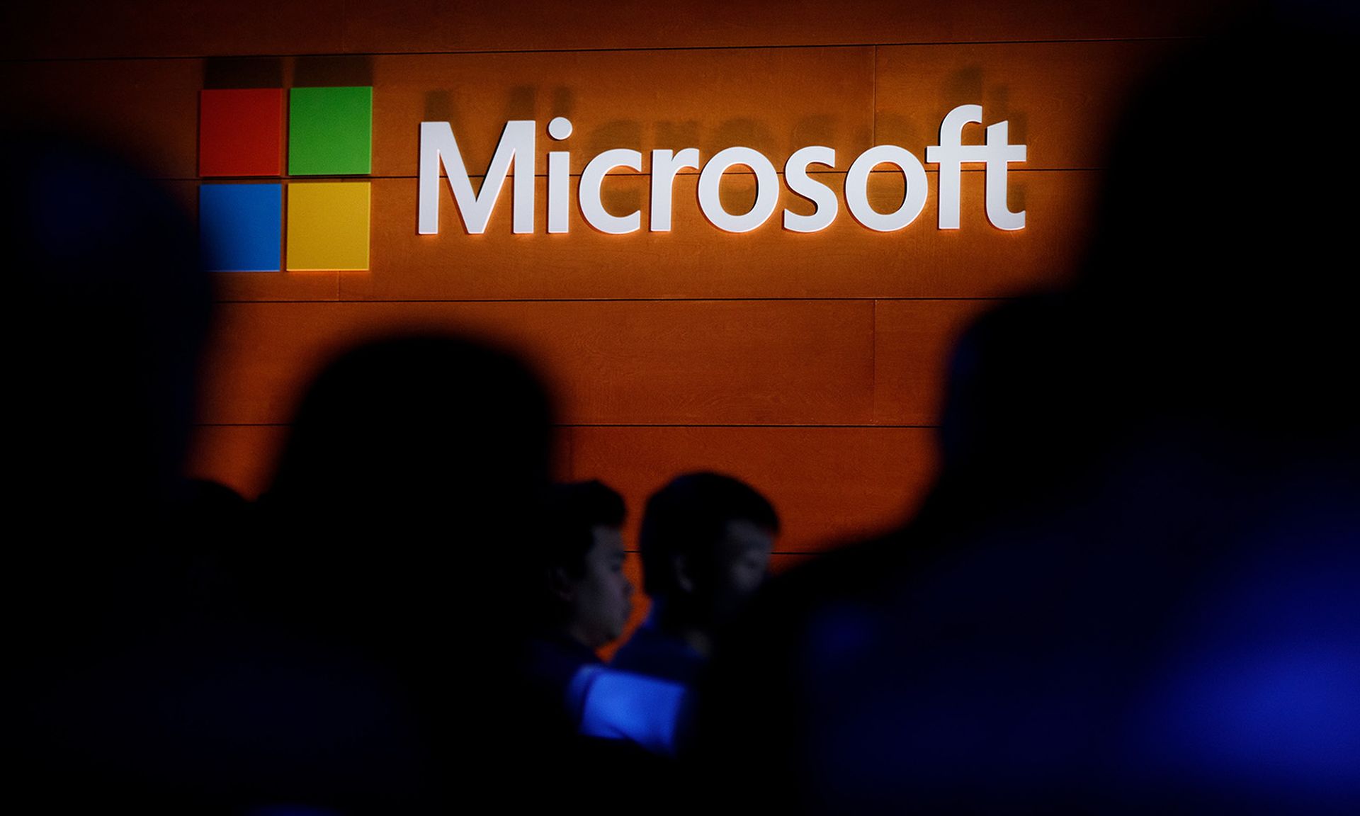The Microsoft logo is illuminated on a wall during a May 2, 2017, launch event in New York City. (Photo by Drew Angerer/Getty Images)