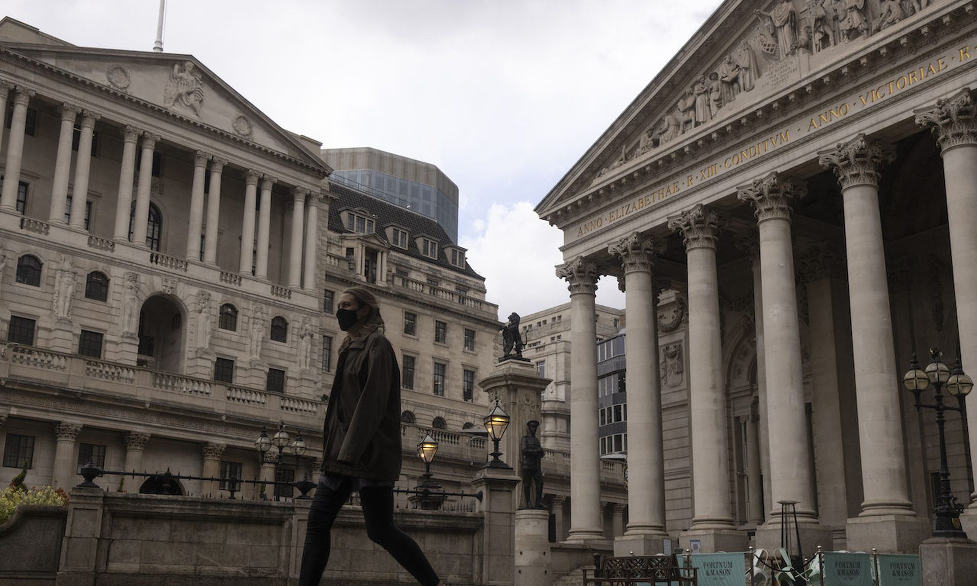 A woman walks past the Bank of England on May 18, 2021 in London. Today’s columnist, Tom Brennan of CREST USA, says he has worked closely with the Bank of England to work on a methodology to improve cyber threat intelligence. (Photo by Dan Kitwood/Getty Images)