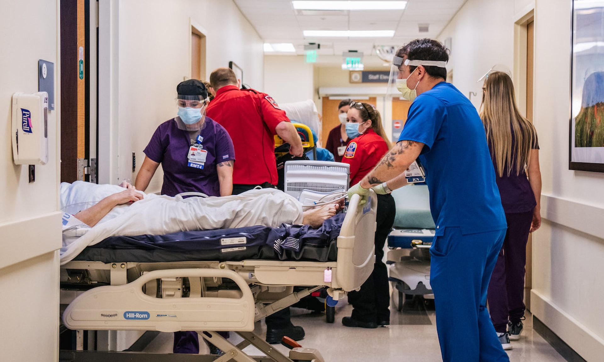 Emergency Room nurses and EMTs tend to patients in hallways at the Houston Methodist The Woodlands Hospital on August 18, 2021. A ransomware group dubbed by Mandiant as FIN12 tends to install Ryuk and focuses heavily on the health care sector.  (Photo by Brandon Bell/Getty Images)