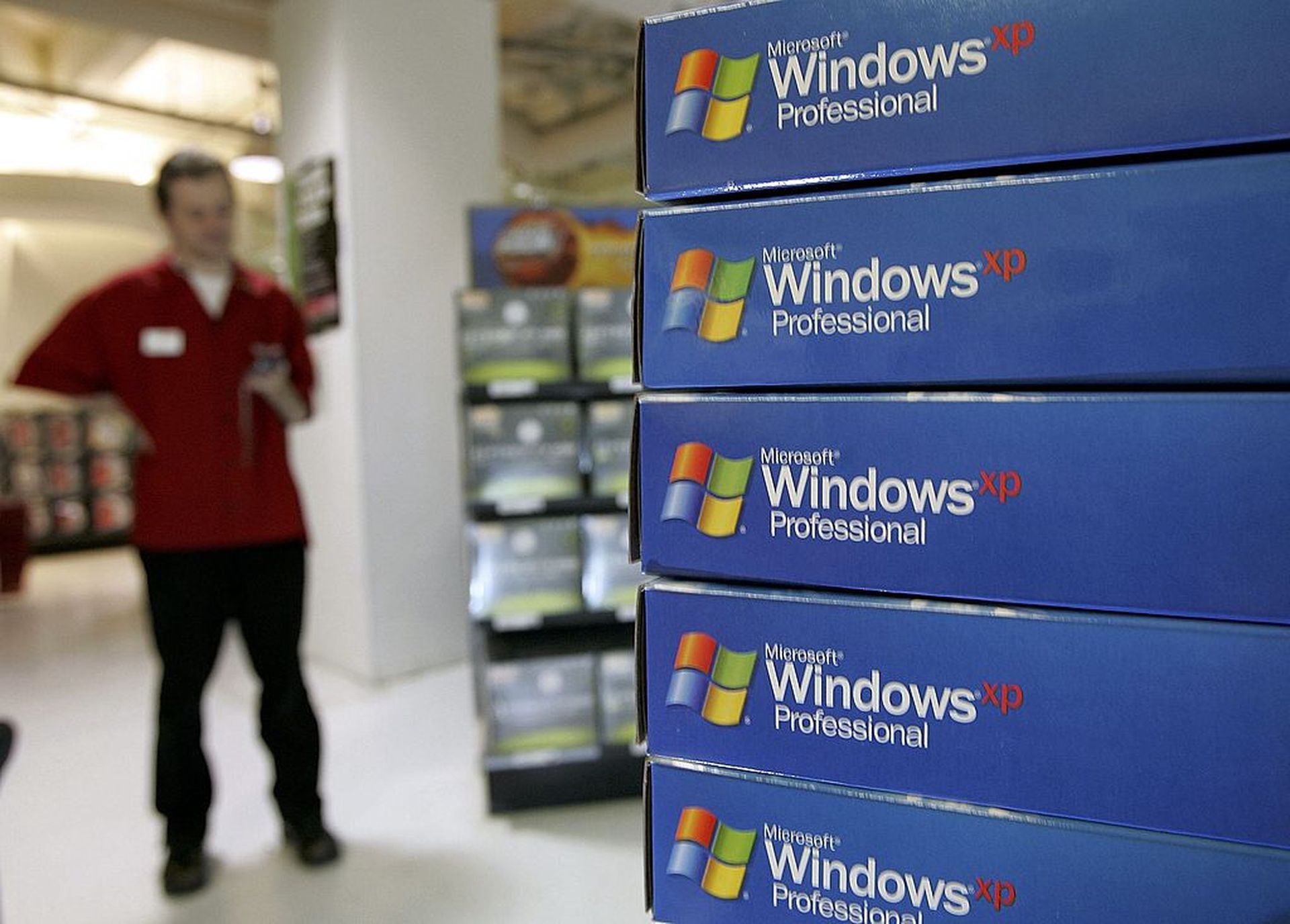 Many healthcare provider organizations continue to rely on outdated, unsupported, legacy technology like Windows XP, which poses critical risks to the enterprise. Pictured: A CompUSA sales associate stands near a display of Microsoft Windows XP software March 22, 2006, in San Francisco. (Photo by Justin Sullivan/Getty Images)