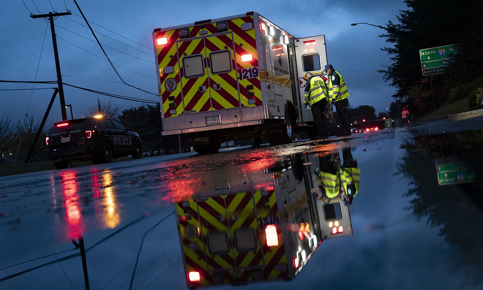 Firefighters and paramedics with Anne Arundel County Fire Department board their ambulance after loading a patient while responding to a 911 emergency call on Nov. 11, 2020, in Glen Burnie, Md. (Photo by Alex Edelman/Getty Images)