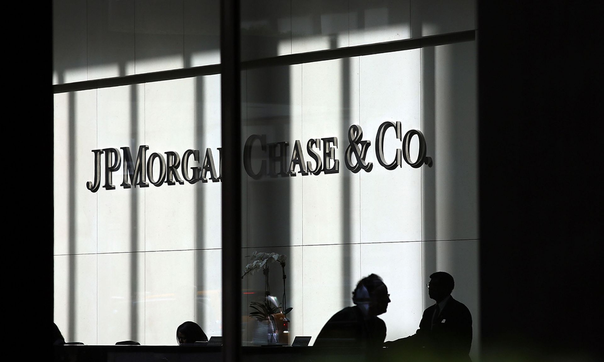 NEW YORK, NY &#8211; OCTOBER 02:  People pass a sign for JPMorgan Chase &amp; Co. at it&#8217;s headquarters in Manhattan on October 2, 2012 in New York City. New York Attorney General Eric Schneiderman has filed a civil lawsuit against JPMorgan Chase alleging widespread fraud in the way that mortgages were packaged and sold to investors in the day...