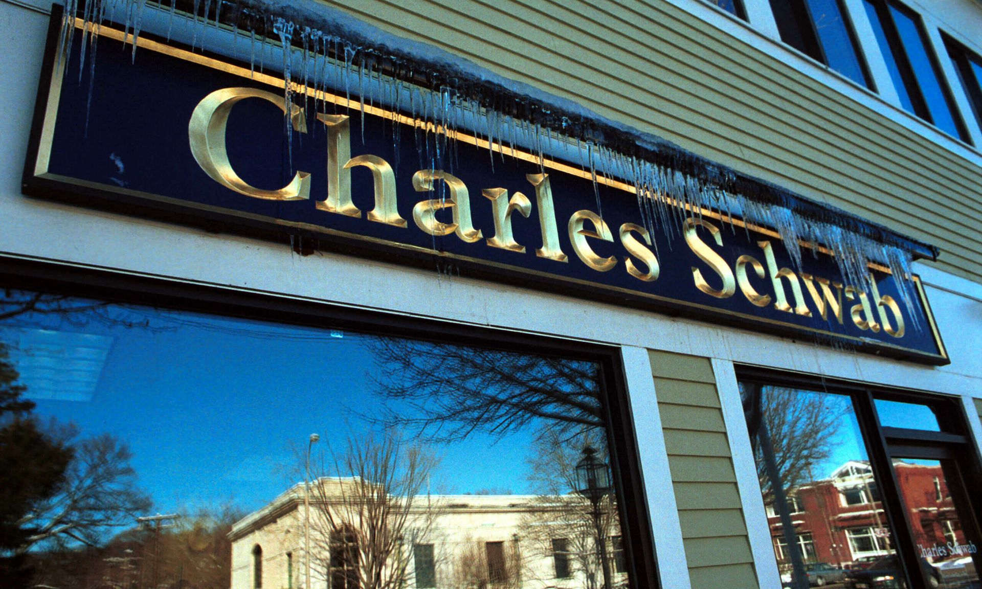 Icicles hang on a Charles Schwab sign January 10, 2001 in Lexington MA. Financial advisory firms face distinct risks tied to cybersecurity. (Photo by Darren McCollester/Newsmakers)