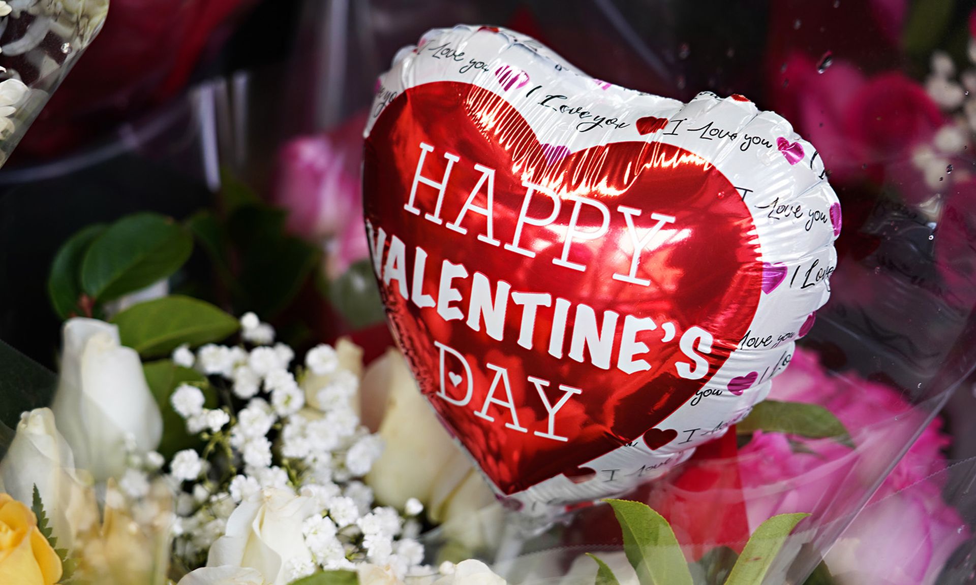 Researchers reported that customers of UnionBank of the Philippines were targeted by an SMS phishing attack offering a Valentine&#8217;s Day gift. Pictured: Valentine&#8217;s Day balloons and flowers are sold outside a convenience store on Feb. 14, 2021, in New York City. (Photo by Cindy Ord/Getty Images)