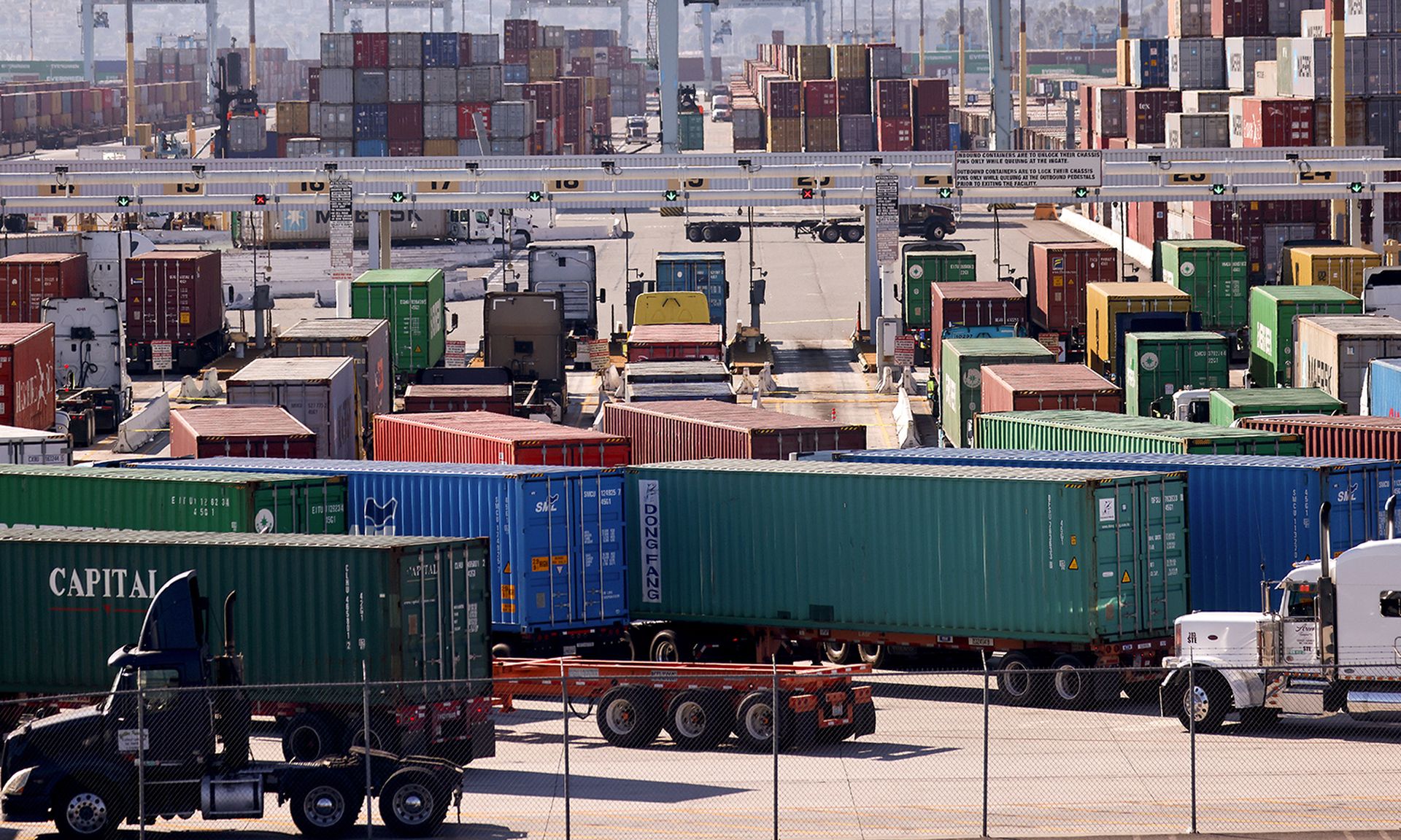 Products such as ATMS, card readers and financial software is susceptible to supply chain threats, said one expert Pictured: Trucks haul shipping containers at the Port of Los Angeles on Nov. 24, 2021, in San Pedro, Calif. (Photo by Mario Tama/Getty Images)