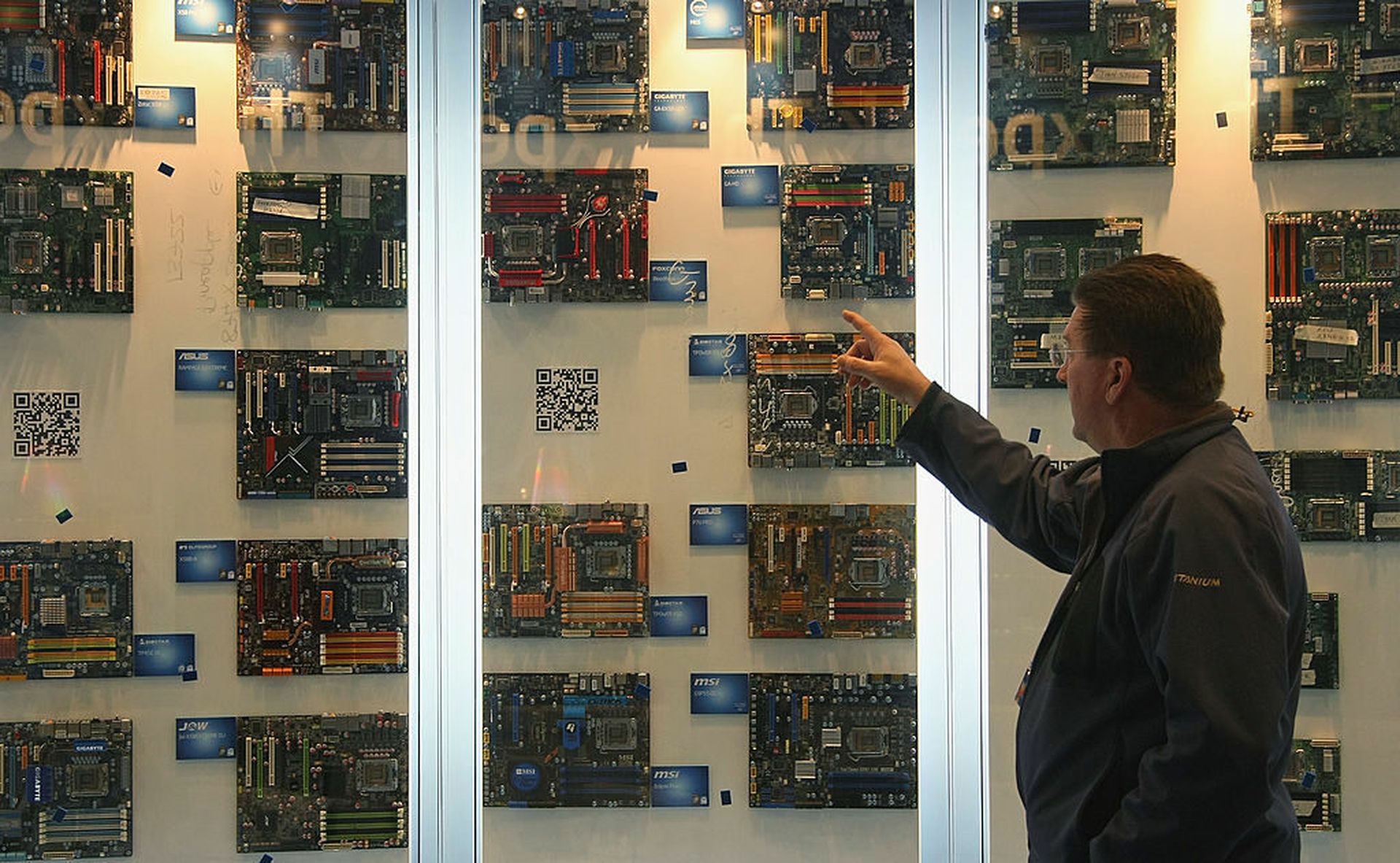 An employee points at motherboards at the Intel stand at the 2009 CeBIT technology trade fair. The National Institute for Standards and Technology are prepping for a supply chain focused update to its Cybersecurity Framework. (Photo by Sean Gallup/Getty Images)