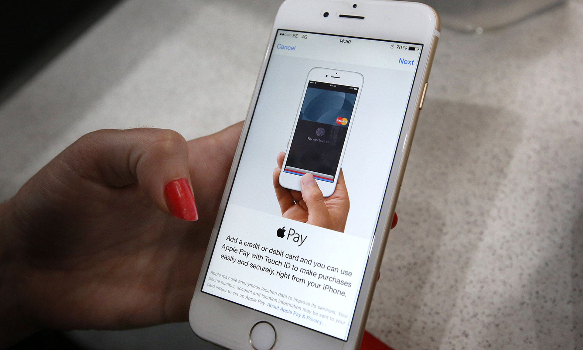 An iPhone is used to make an Apple Pay purchase at The Post Office on July 14, 2015, in London. (Photo by Peter Macdiarmid/Getty Images)