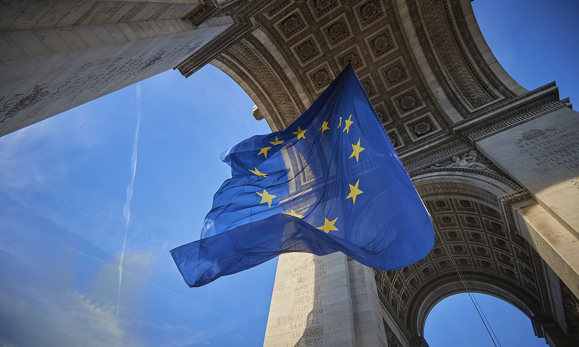 A giant flag of the European Union flies at the Arc de Triomphe on the 20th anniversary of the introduction of the euro on Jan. 1, 2022, in Paris. (Photo by Kiran Ridley/Getty Images)