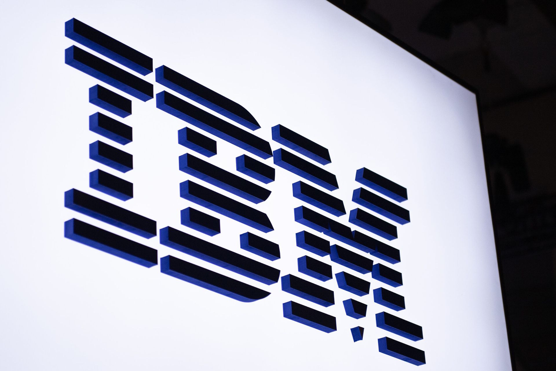 BARCELONA, SPAIN &#8211; FEBRUARY 28: A logo sits illuminated outside the IBM booth at the SK telecom booth on day 1 of the GSMA Mobile World Congress on February 28, 2022 in Barcelona, Spain. The annual Mobile World Congress hosts some of the world&#8217;s largest communications companies, with many unveiling their latest phones and wearables gadg...