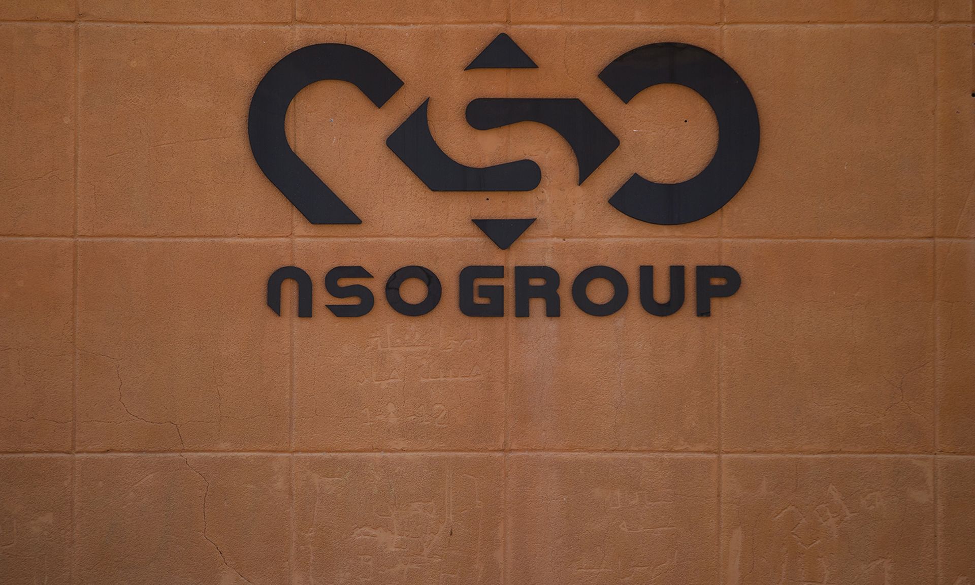 A reported sale of spyware vendor NSO Group to a U.S. defense contractor would invite scrutiny from regulators, experts say. Pictured: The logo of Israeli cyber company NSO Group seen at one of its branches in the Arava Desert on Nov. 11, 2021, in Sapir, Israel. (Photo by Amir Levy/Getty Images)
