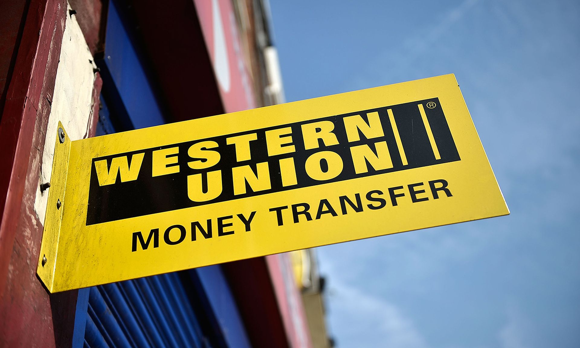 Identity service provider Okta was used to breach a number of financial services, including Western Union. Pictured: A money transfer shop is seen Sept. 24, 2013, in London. (Photo by Bethany Clarke/Getty Images)