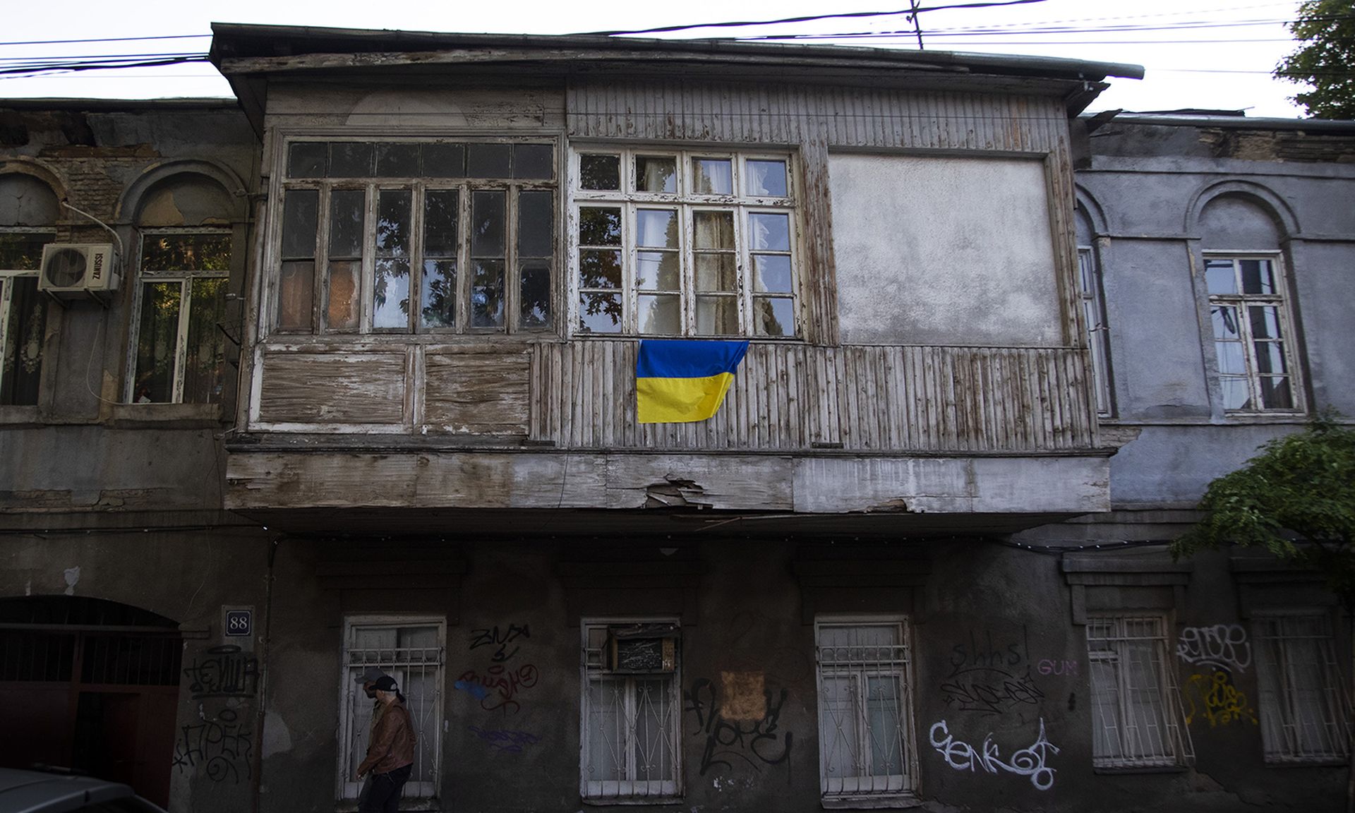 Identity issues become a problem for refugees displaced by conflict, such as those fleeing Ukraine during the Russian invasion. Pictured: Ukrainian flags are displayed in various locations around Tbilisi, Georgia, to show support for Ukraine on May 21, 2022. (Photo by Daro Sulakauri/Getty Images)